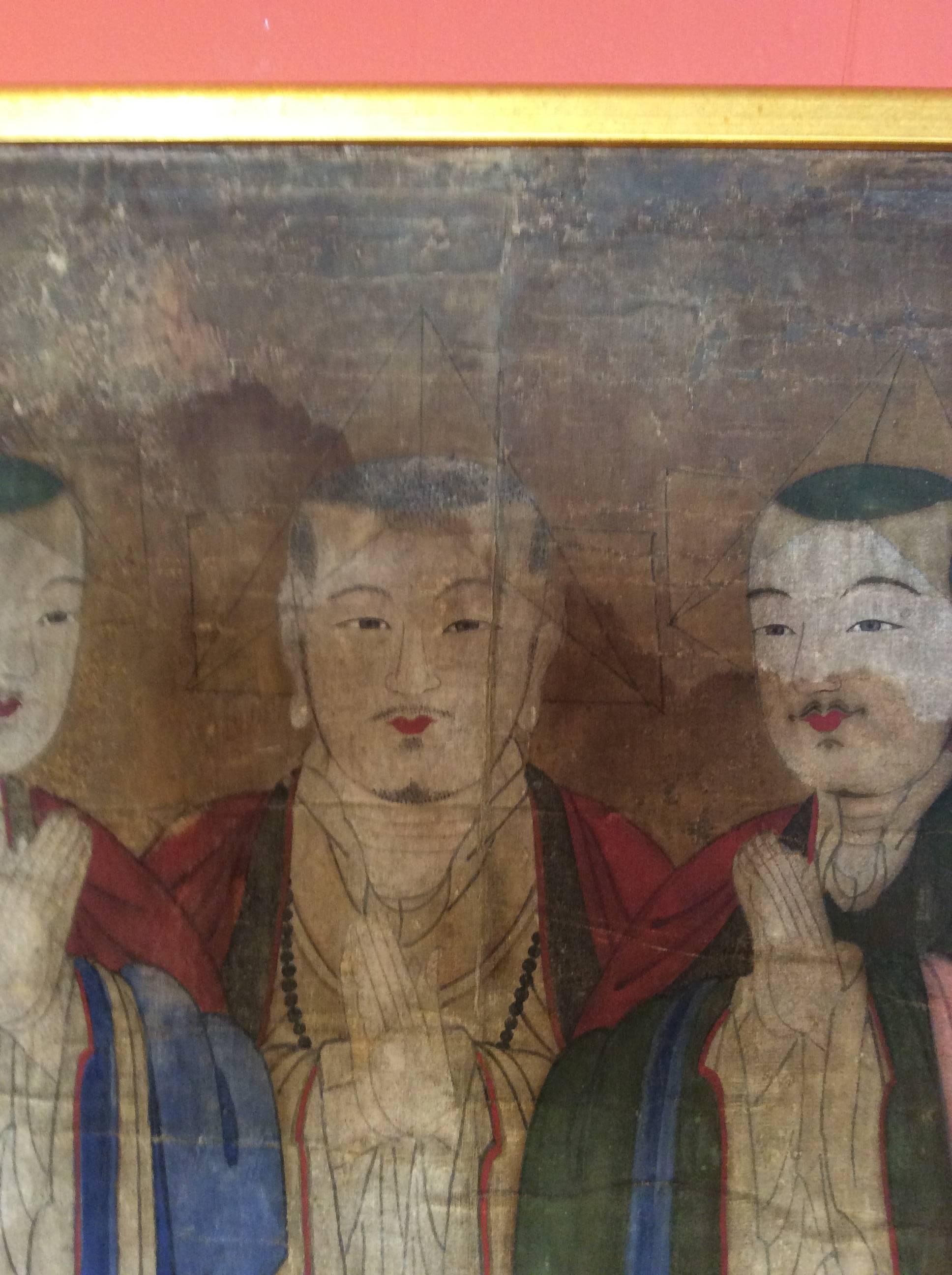 Antique Chinese painting of three figures on fabric. The painting is delicate, with great care given to the faces. 
There is some discoloration in the fabric. It has been framed and mounted in the last twenty years.