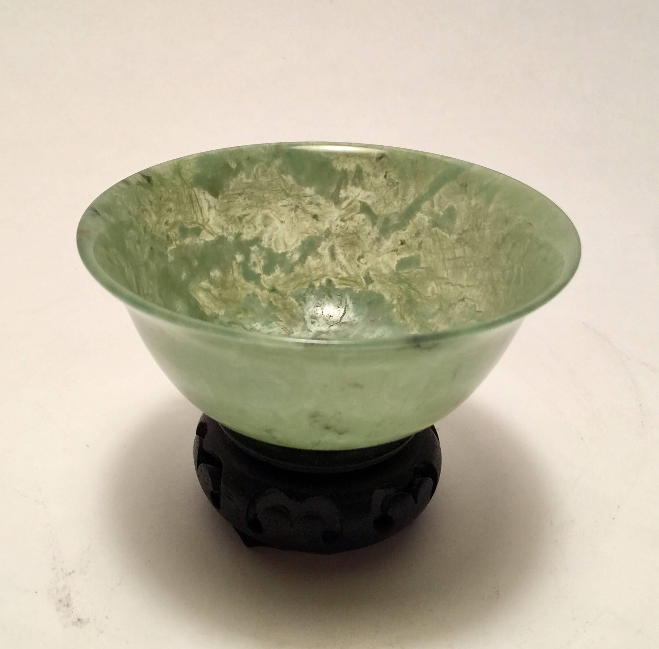 A beautiful 20th century Chinese jade footed bowl. The stone is nicely mottled, very thin and translucent. 1.75