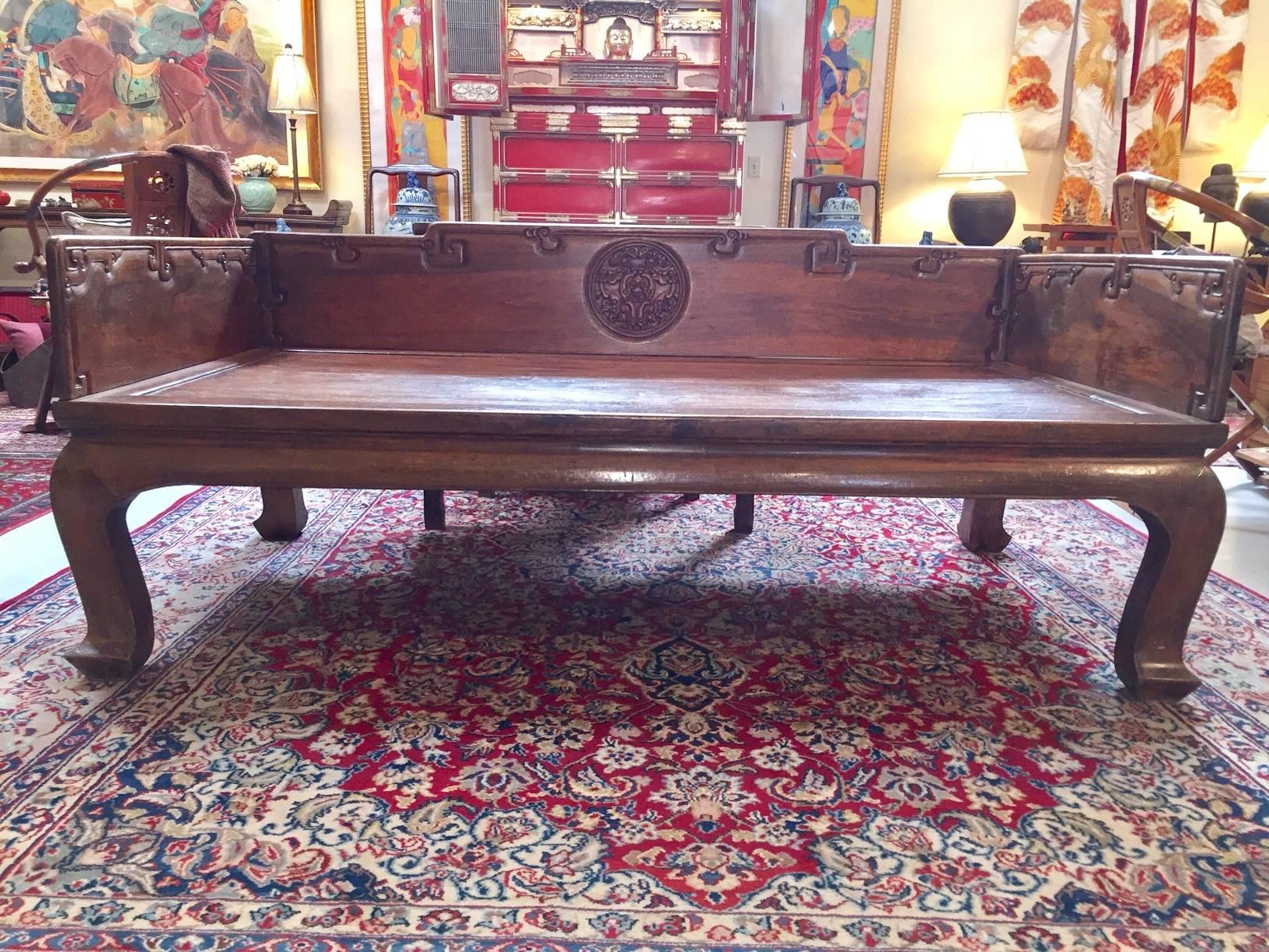Over 180 years old, this walnut bed would have belonged to a wealthy family as evidenced by both the rich dark walnut wood and detailed carving. The carving includes a medallion on the back board depicting bats (symbols of good fortune in China).