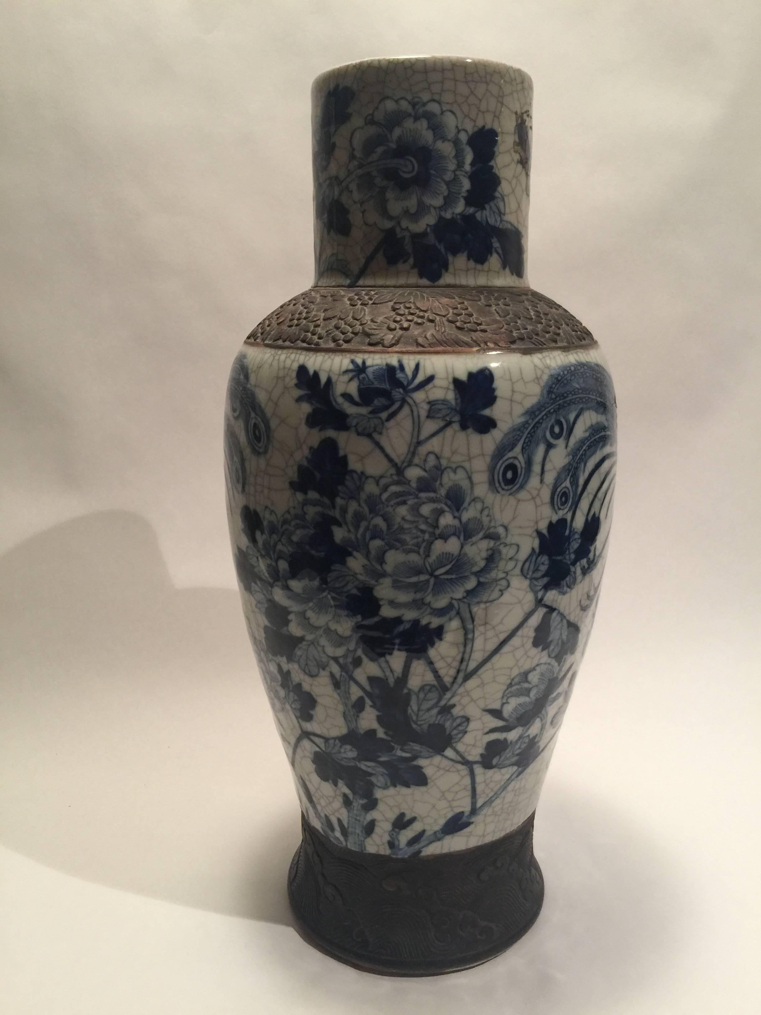 A large vase of porcelain decorated with two beautiful Phoenix birds and peonies. Two iron oxide bands circle the piece. The Tongzhi chop on the bottom is undecipherable due to the fact that it has been drilled through -most likely to create a lamp.