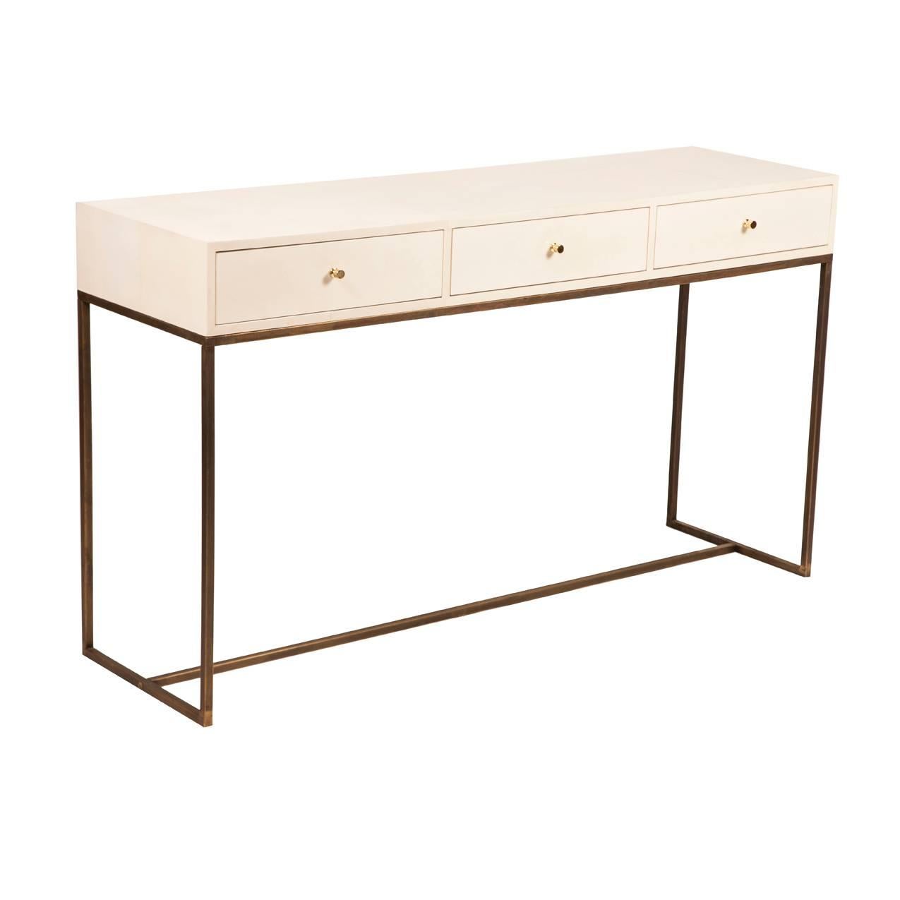 White (RAL 9001) piano lacquered console table with brass lined drawers, antique brass frame base, vellum parchment front drawer detail and brass pull knobs.

W140 x D40 x H85 cm

Lead time: 10 - 14 weeks