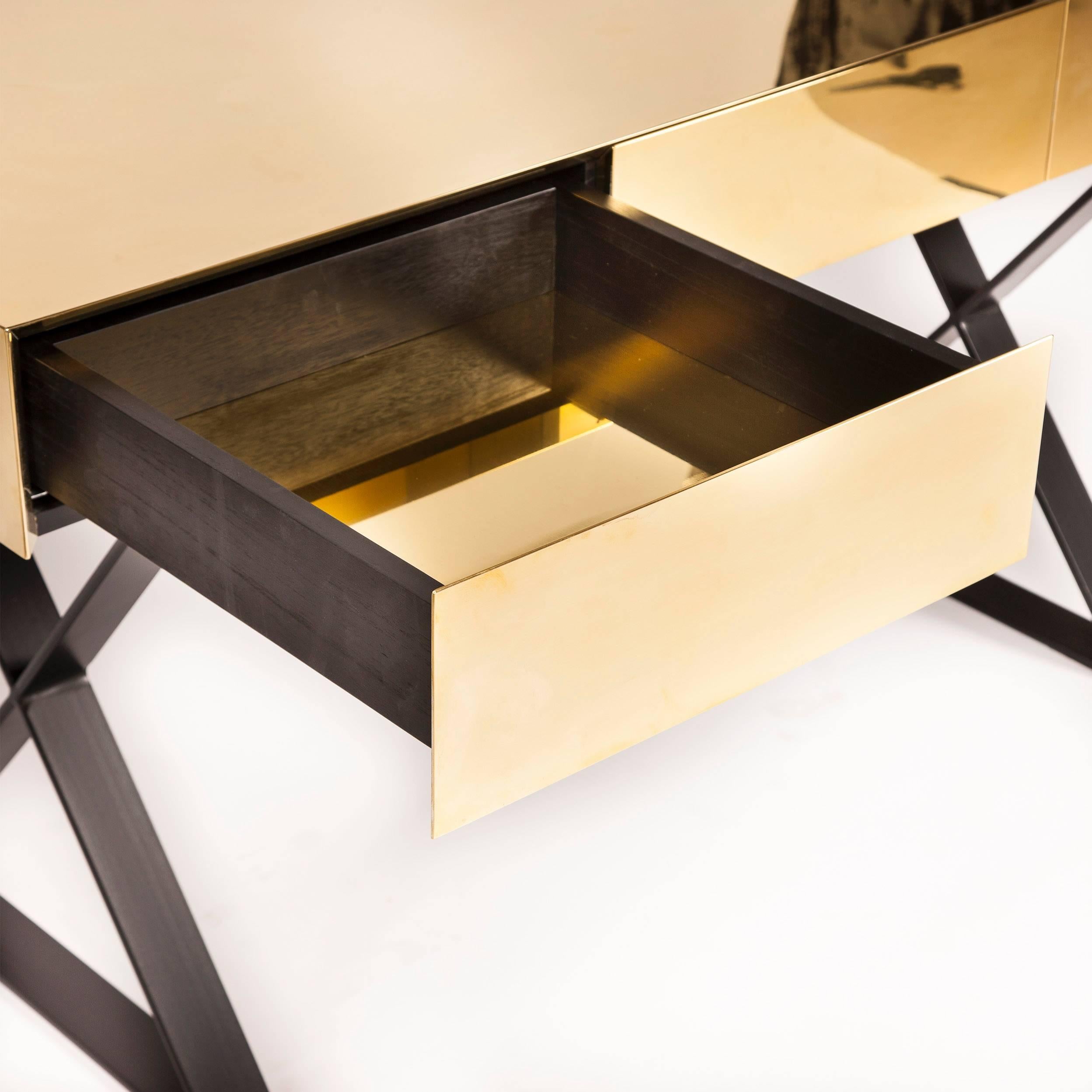 Seamless polished brass desk with brass lined pull-to-open drawers and matt black metal legs. Lacquered. Also available in antique brass or bronzed finish. Bespoke dimensions and finishes available on request.

W160 x D60 x H75 cm

Lead time: 8 - 10