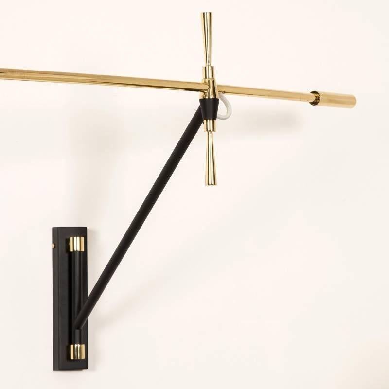 Polished brass and matt black wall light with swinging arm. Lampshade is not included.

Height: 20 cm, depth of fixed black arm: 45 cm, total length of brass arm: 125 cm, length of brass arm from black fixing to the shade: 85 cm.

Currently in