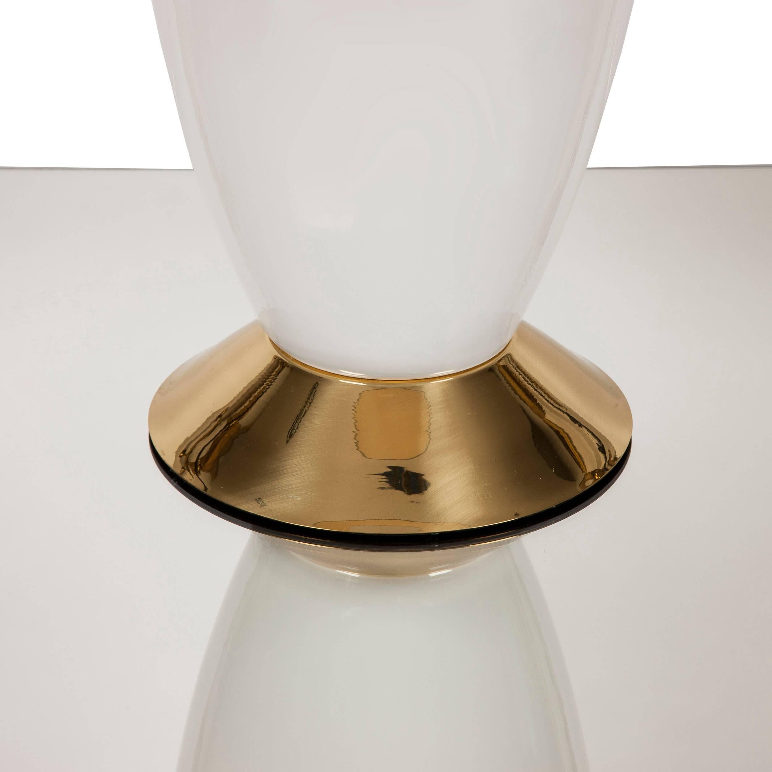Large ceramic table lamp on polished brass base. A classically inspired piece with elegant lines and shape. 

Measures: 62 cm high x 25 cm diameter

Lampshade is not included.