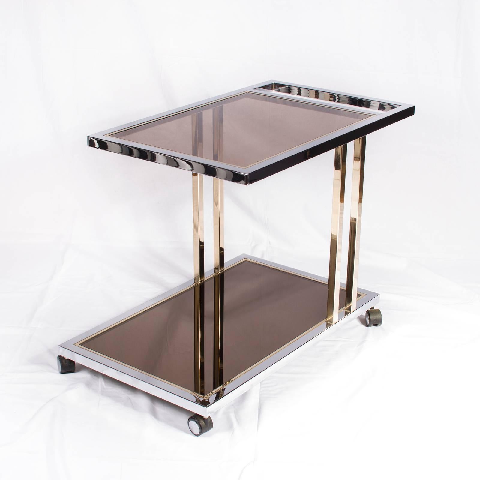 23-Carat gold-plated and chrome with smoky glass and bronze mirror, asymmetrical two tier bar cart, by Belgochrome.

Please contact us for delivery details.