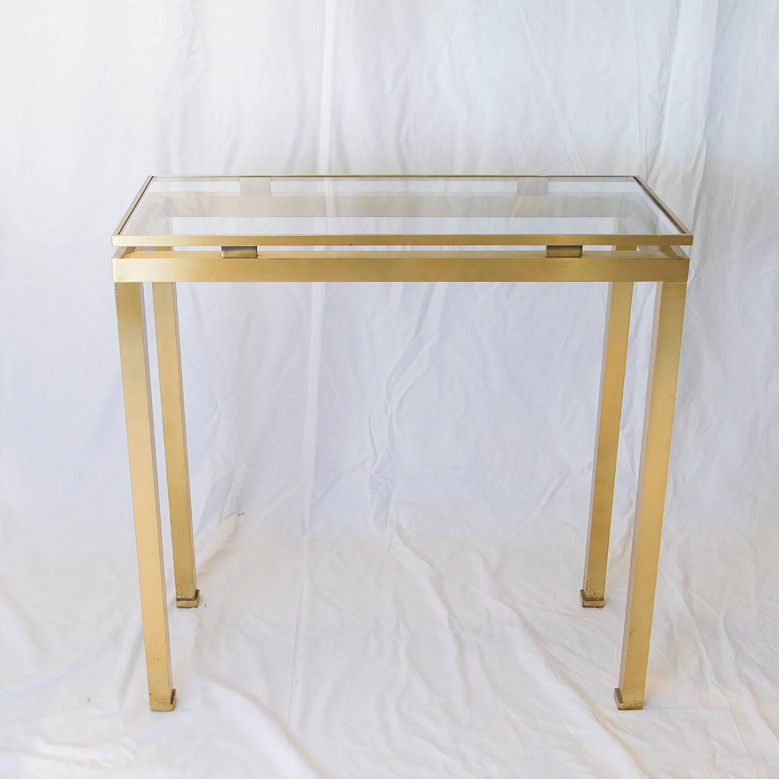 Golden brushed steel console with glass top by Guy Lefevre for Maison Jansen.