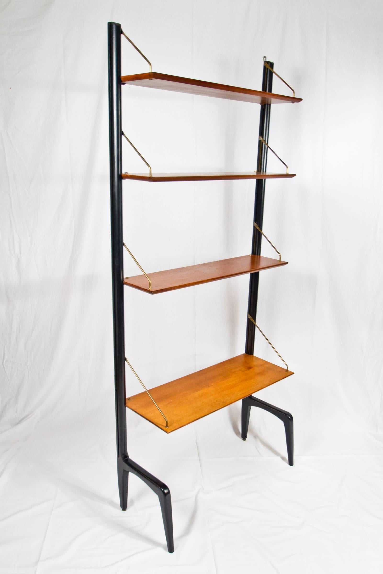Beautiful modular shelving system in blackwood, teak and brass hardware, designed by Louis Van Teeffelen, 1950s. It's a modular design which can be extended. More shelves like this one can be stacked next to each other.

Excellent vintage