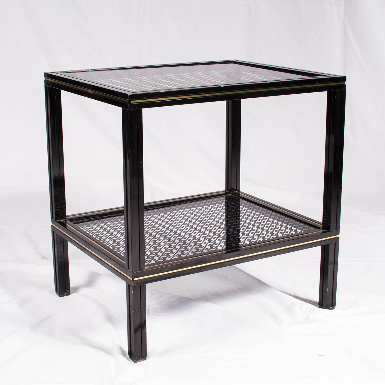 French vintage side table by Pierre Vandel in black lacquered metal with two shelves glass have a cane work pattern applied.