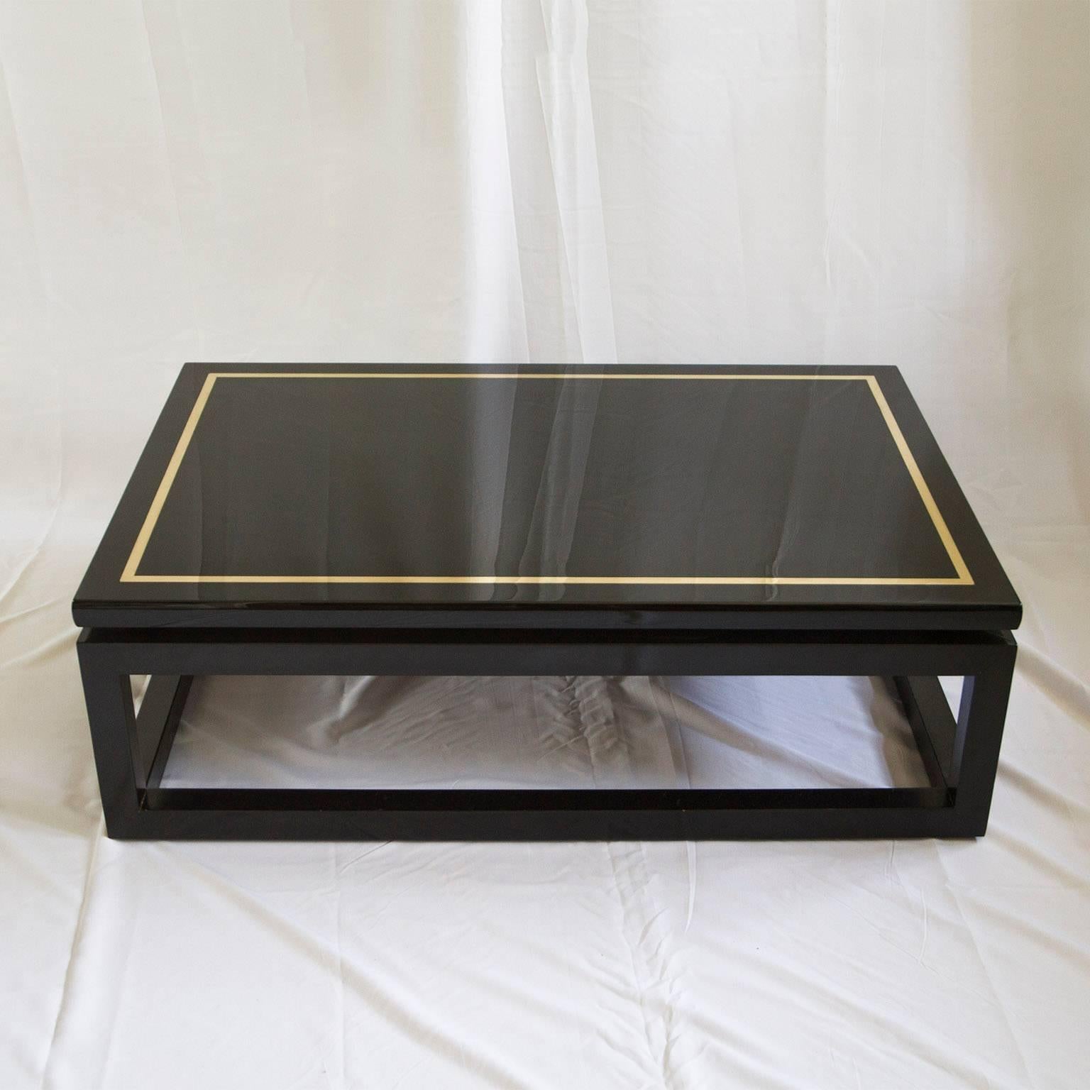 Black lacquer and brass coffee table in beautiful state. We also offer a matching pair of side tables.