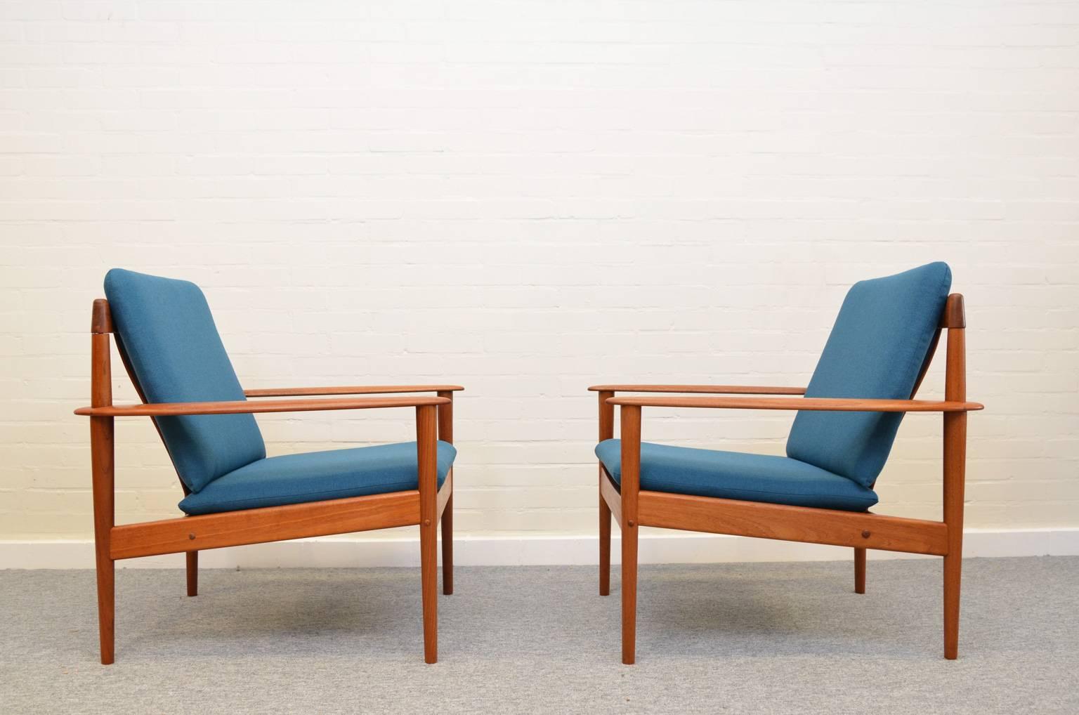 Two easy chairs model PJ56 in teak with new blue upholstery. Simple and elegant, typical for designs by Grete Jalk. Marked under the seating. 