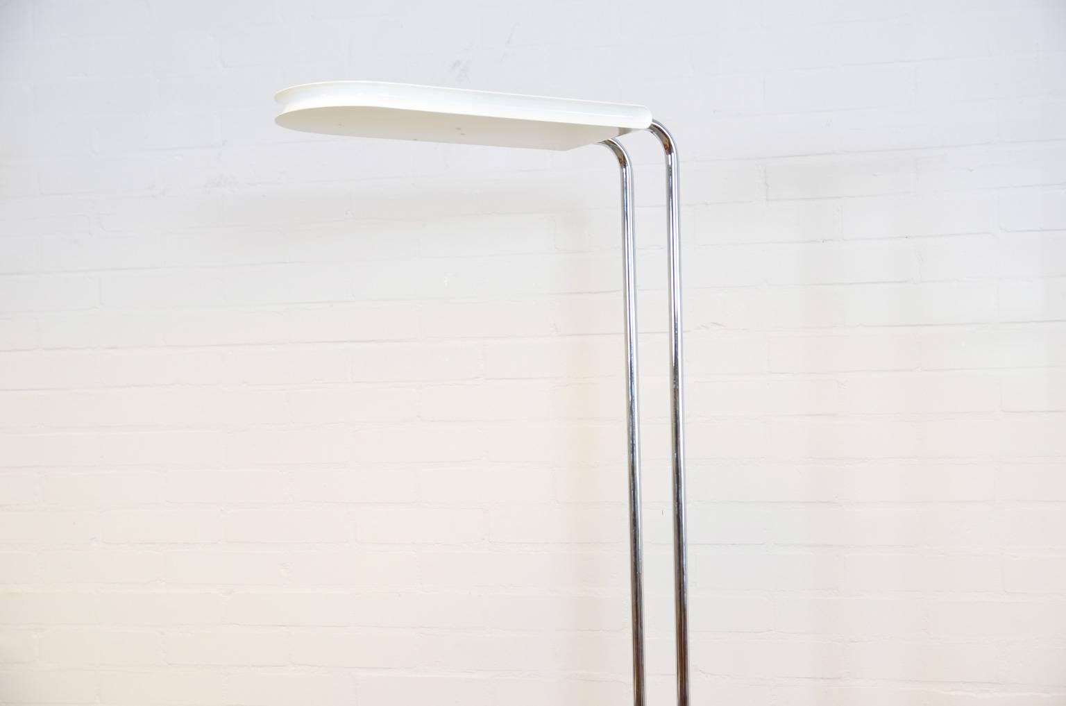 The halogen floor lamp has a marble square and heavy base, chromed stands ending at 222 cm in a white (metal) hood. The lamp is in a good and all original condition.
 
