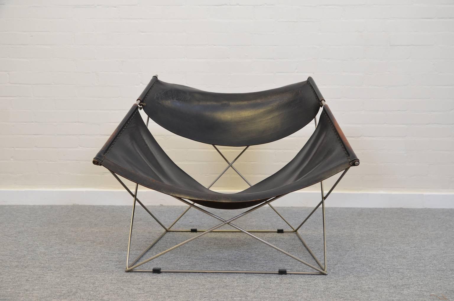 Pierre Paulin designed the butterfly chair (model F765) for the Dutch manufacturer Artifort. Original black leather seating hanging in a crossed tubular metal frame.