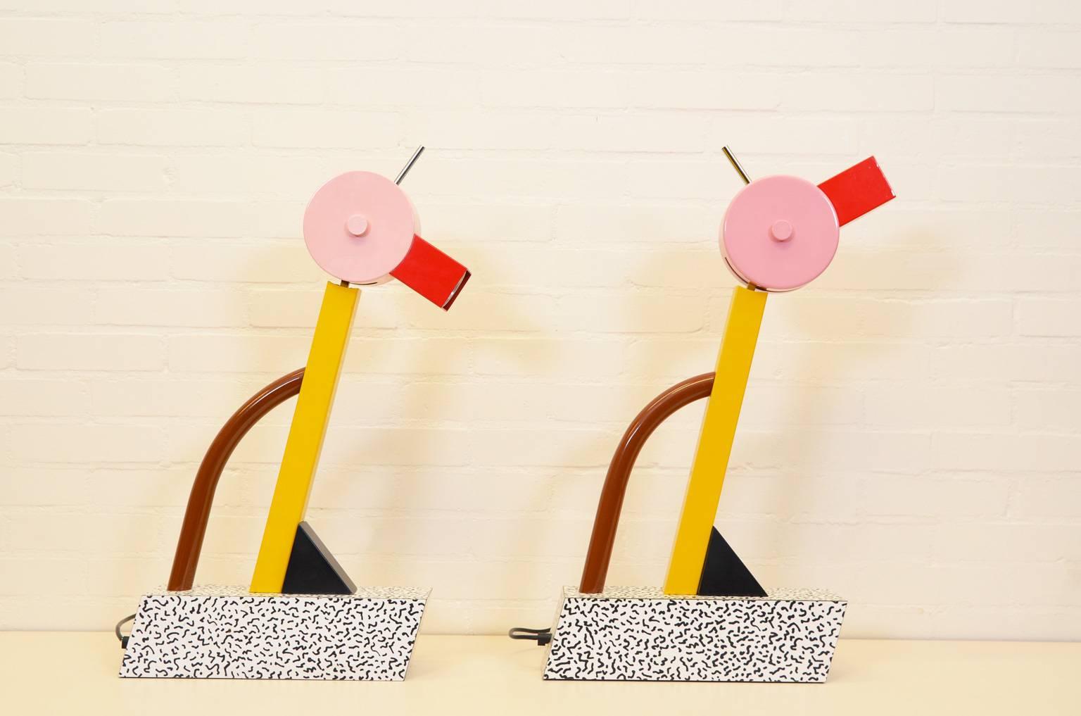 Table lamp from the striking and colorful Memphis collection. The Memphis Group was founded in 1981 by the architect Ettore Sottsass. Designs of the group are characterized by the use of bright colors, different designs, shapes and materials. In the