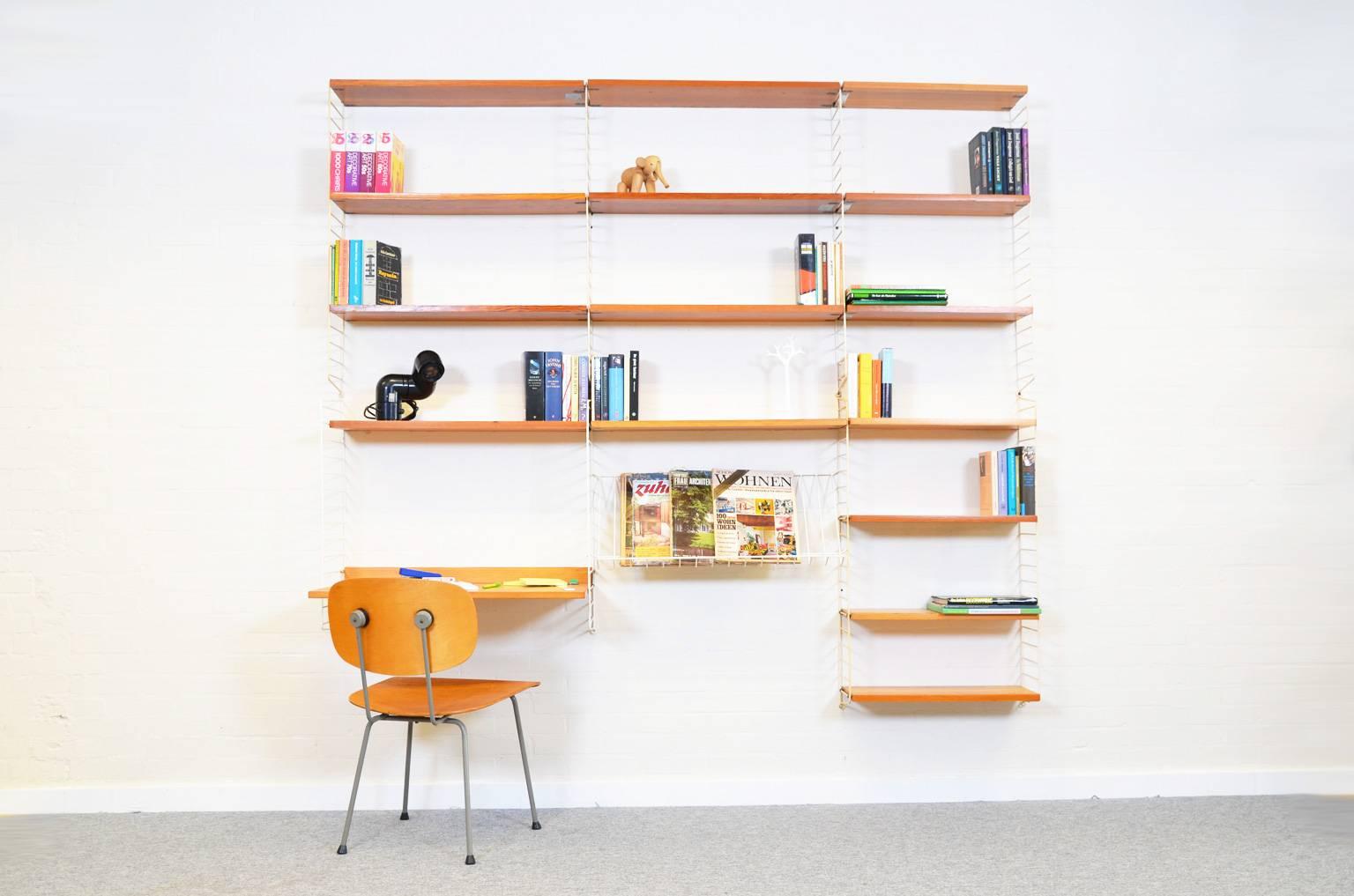 Iconic and transparent shelving system by Nisse Strinning, produced in the 1960s. The system features a small desk, 15 shelves and a wire metal magazine shelf. Manufactured by String design AB, Sweden.