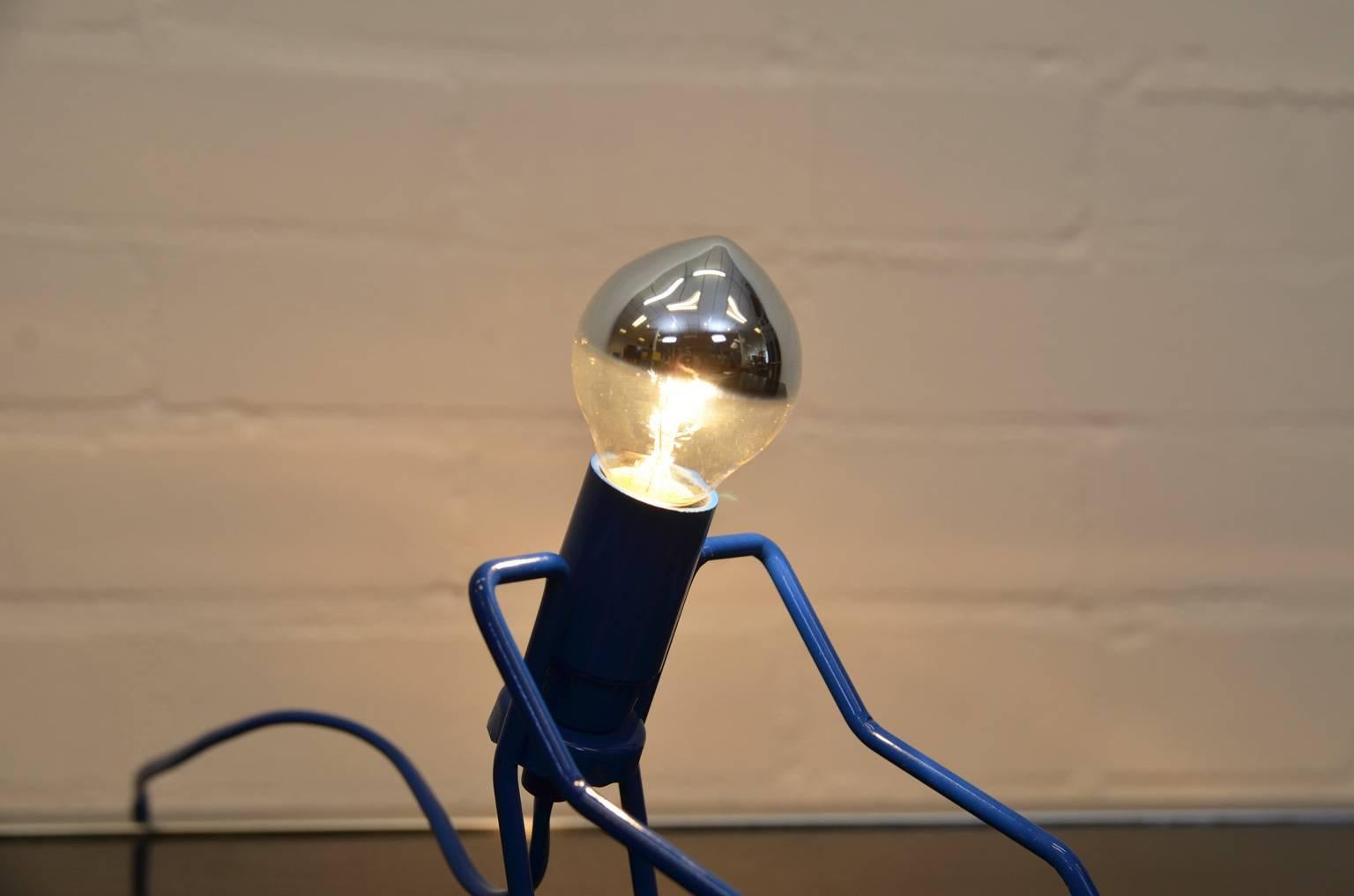 Rare and unique 'man' lamp. Smart use of wired metal and the finishing touch is the lamp depicting the man's head.