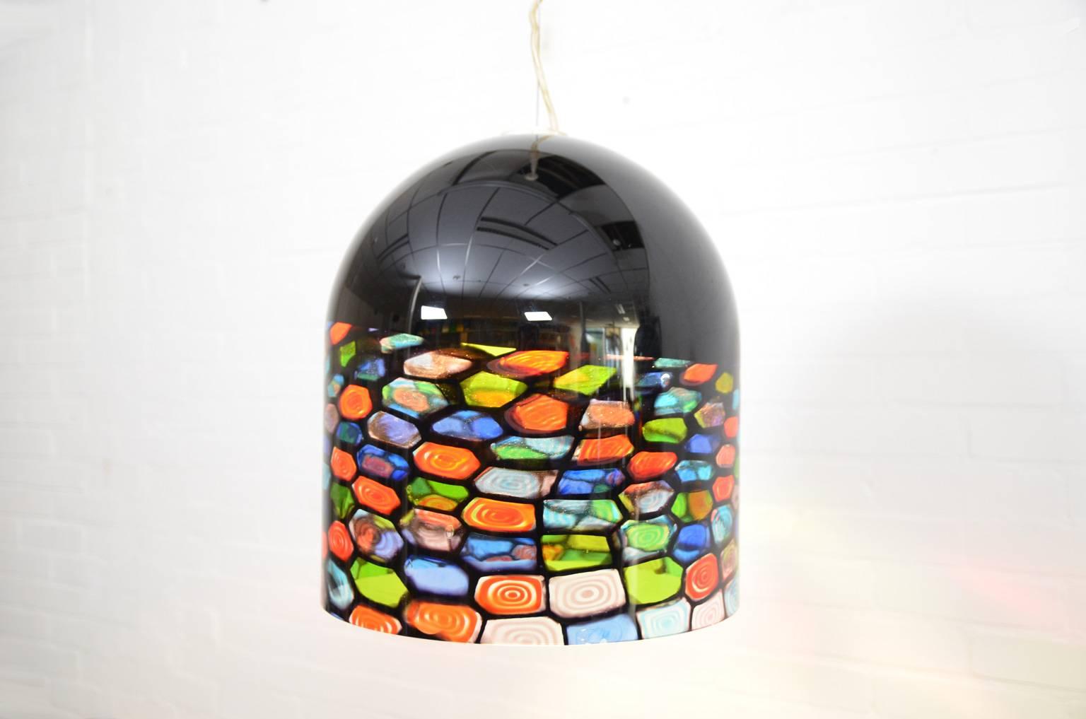 Renato Toso and Noti Massari - husband and wife - were responsible for the designs of the early Leucos lamps. In the 1970s they also designed this heavy and colorful lamp in glass. The cable length is adjustable. One of the lamps has a little chip,