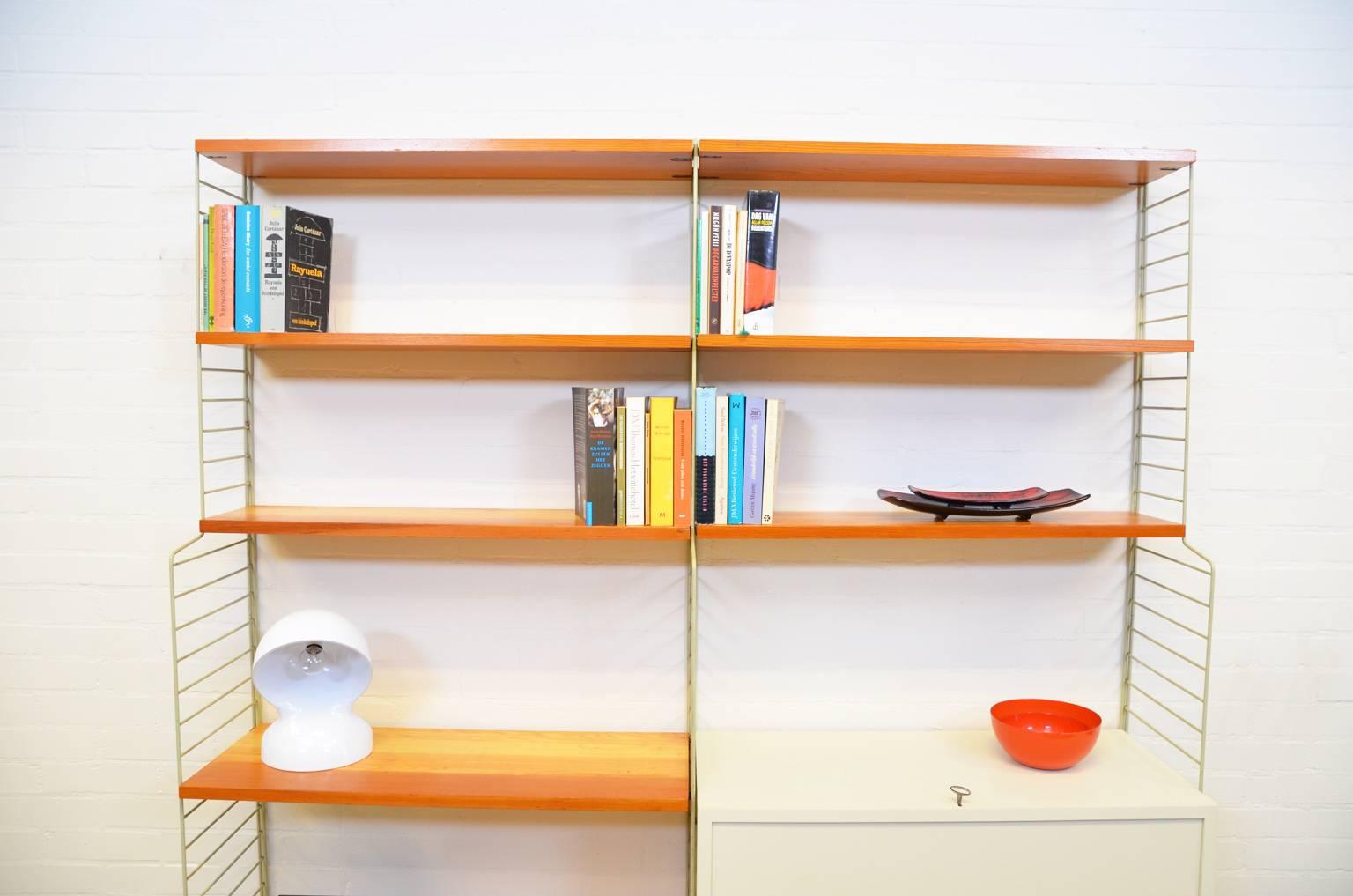 Iconic and transparent shelving system by Nisse Strinning, produced in the 1960s. The cabinet is meant to store records. The interior of the cabinet can be removed very easily to give the cabinet a different purpose. The system is modular, the