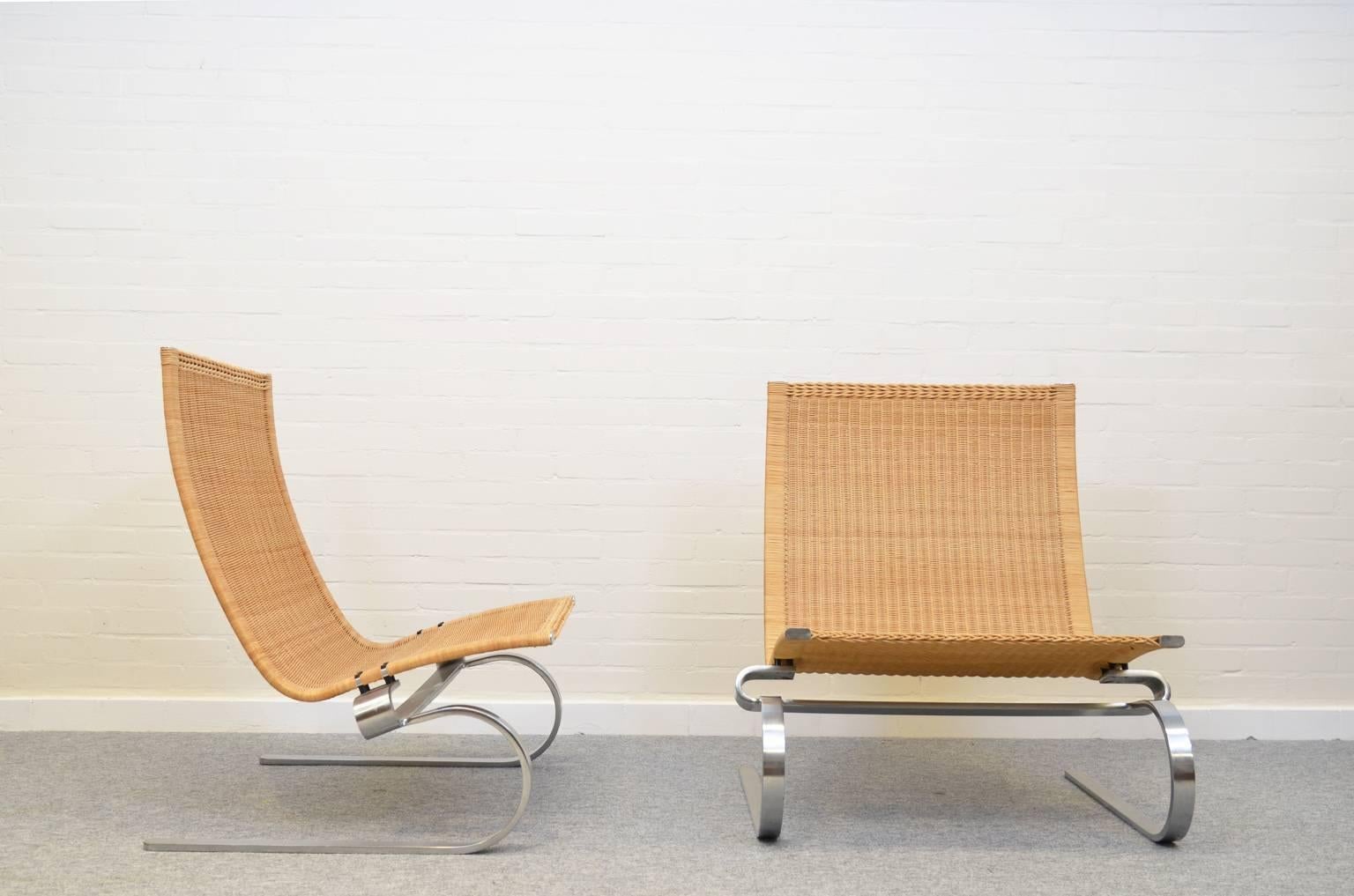 Very comfortable lounge chairs by Poul Kjaerholm. These chairs have their original wicker seating on a matt chrome-plated steel base. Both chairs are in an excellent vintage condition.