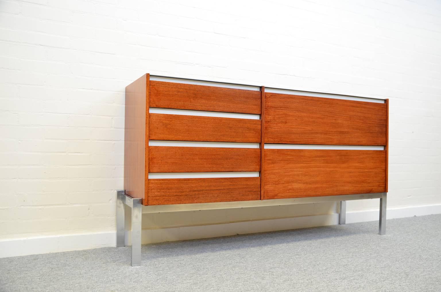 A rosewood sideboard by Kho Liang Ie & Wim Crouwel for Fristho standing on a chrome-plated metal base. This sideboard is in a good and original condition, with minor wear consistent with age and use.