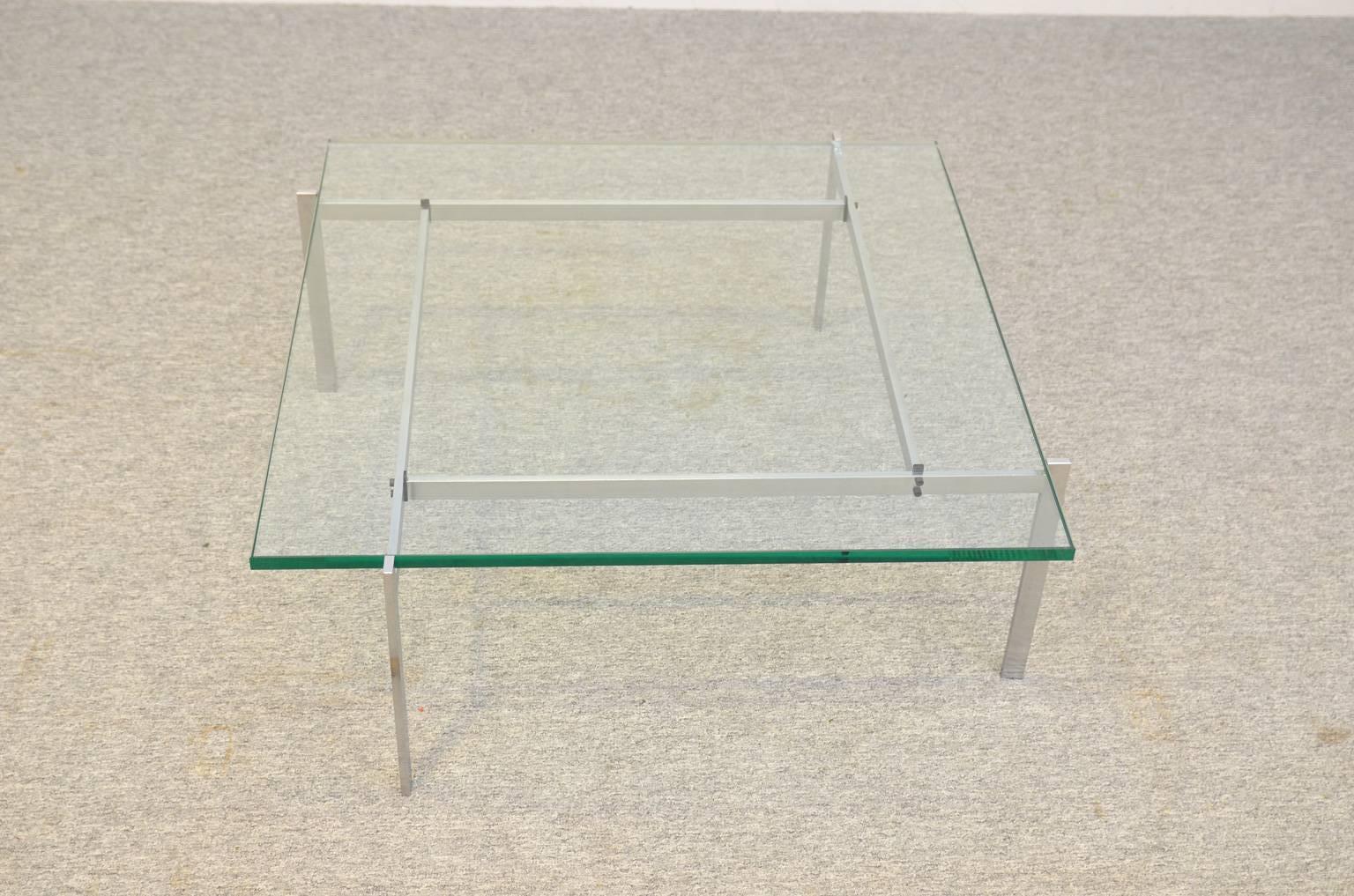Early production midcentury coffee table by Poul Kjaerholm, manufactured by E. Kold Christensen. The stamp of the manufacturer is present on the base (image 10). The glass tabletop is renewed.