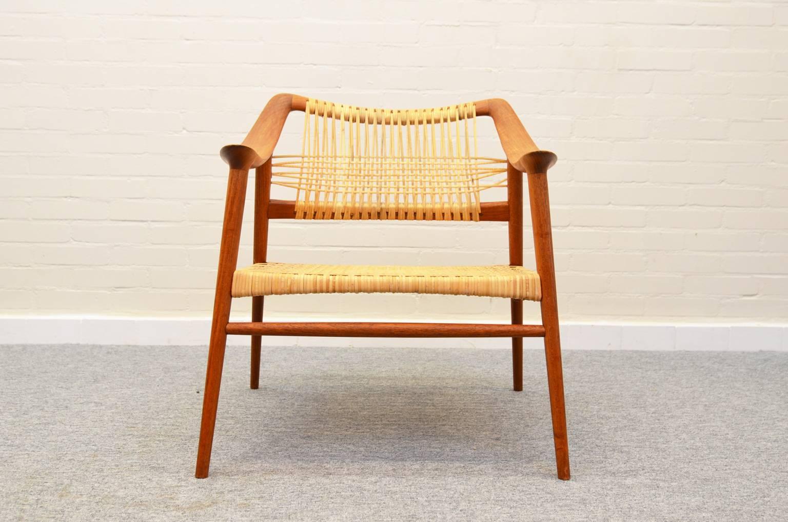 Exceptional armchair designed by Rastad and Relling design office and produced at Gustav Bahus in the mid-1950s. Teak frame and fully restored rattan seating and back.
