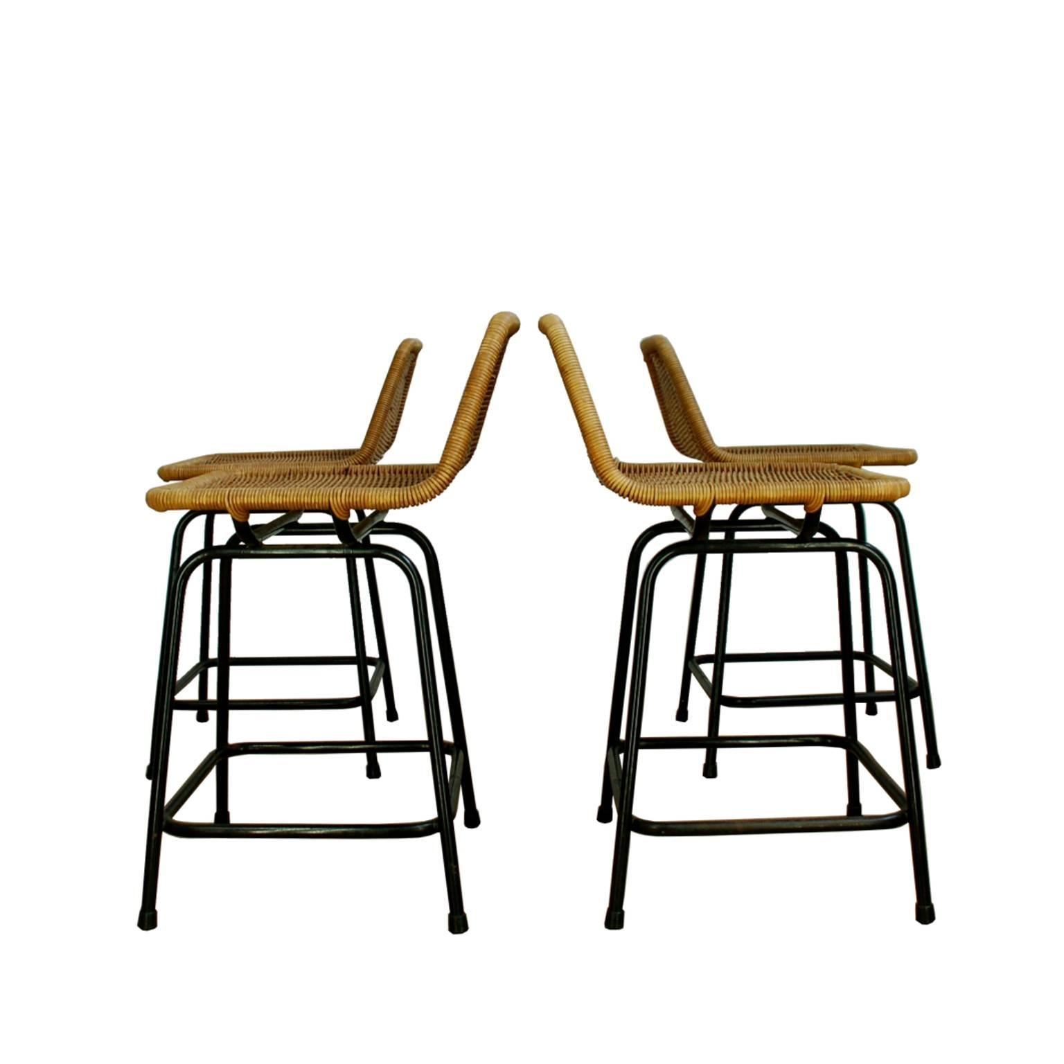 Set of four elegant stools with a black metal frame and wicker seats. They were designed in the 1960 by Dirk Van Sliedrecht and produced by Rohe Noordwolde. Please check the dimensions, these are small, chair-size stools.