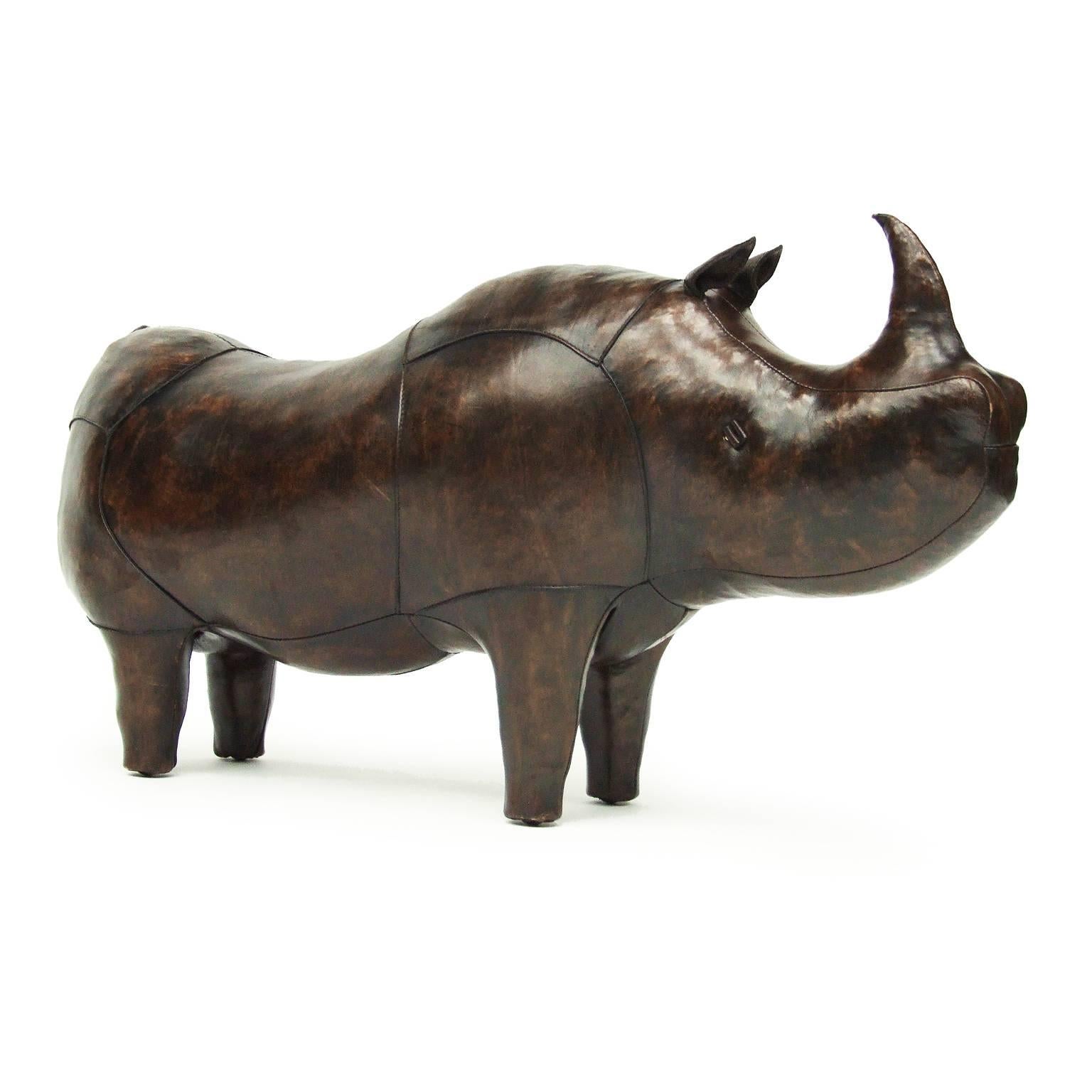 Large rhinoceros footstool designed by Dimitri Omersa for Omersa, UK.

Upholstered brown leather rhino design. Four metal studs.

Measures: H 60 cm x L 105 cm x W 35 cm.