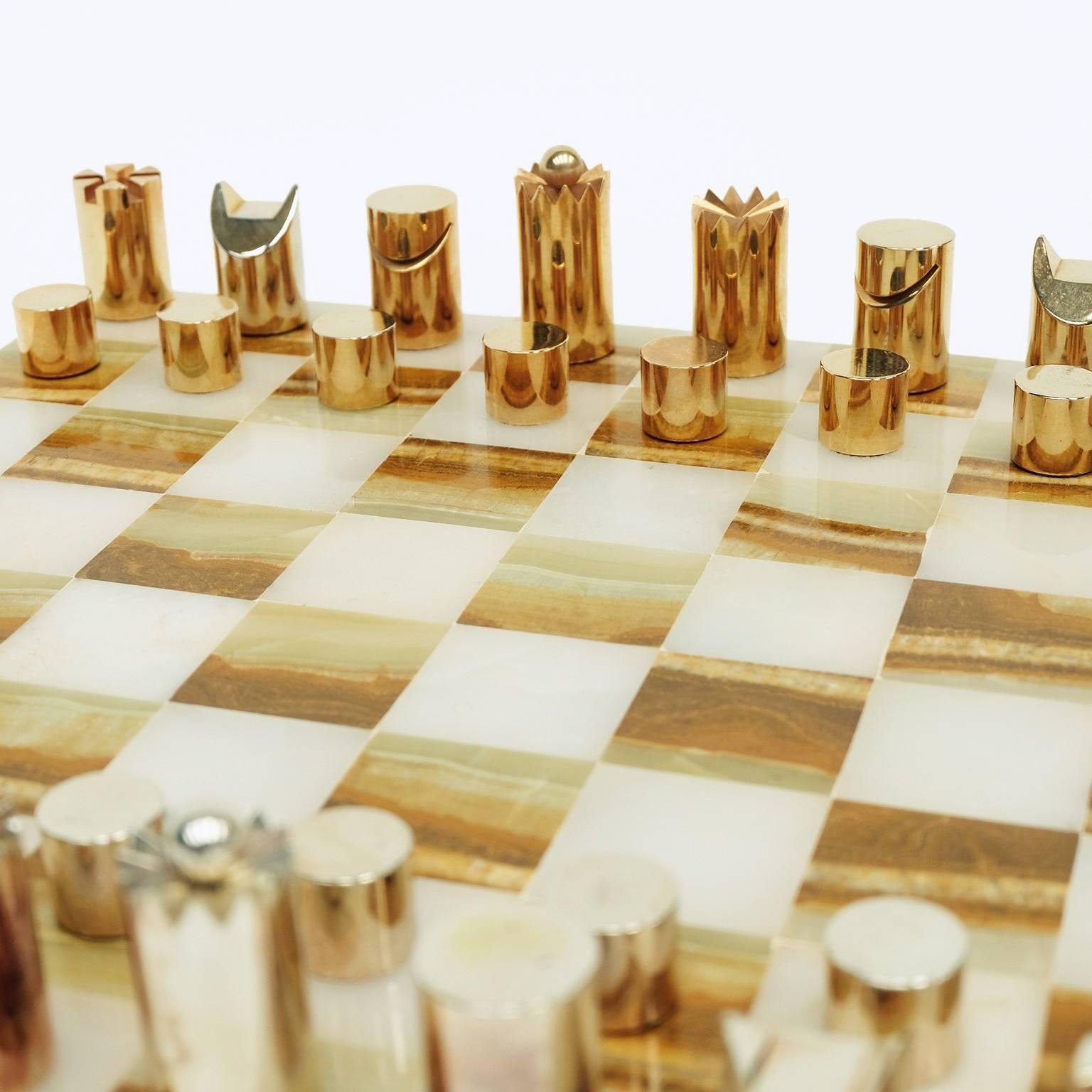 1970s chess set designed and manufactured in Italy.
 
Solid polished gold and nickel-plated steel pieces with an Onyx board.

This is a substantial set that weighs 10 kilos.