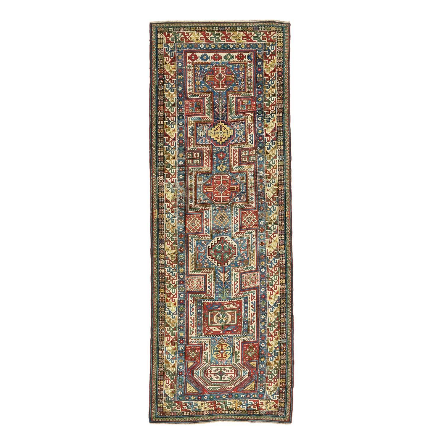 Handwoven from lustrous handspun wool, this antique Shirvan carpet features the simple, dense design elements that distinguish this style of weaving. Weavers often relied on primary vegetable dye palettes of indigo, madder, saffron and ivory to
