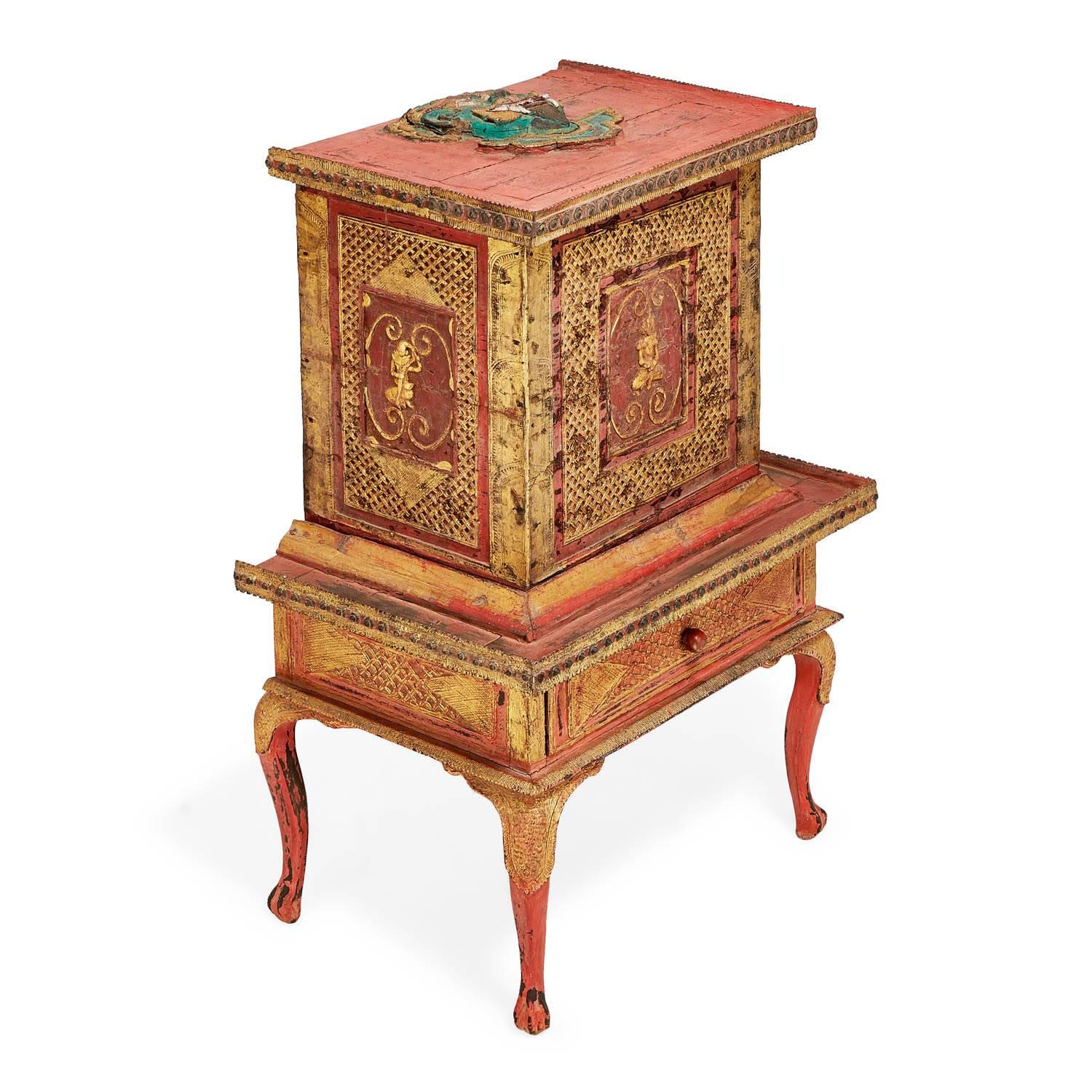 Historically used for donations in a Burmese Buddhist temple circa 1890, a hand-carved and intricately gilt and red painted donation box sits gracefully on curved cabriole legs. Designed with an opening at the top to collect offerings from visitors