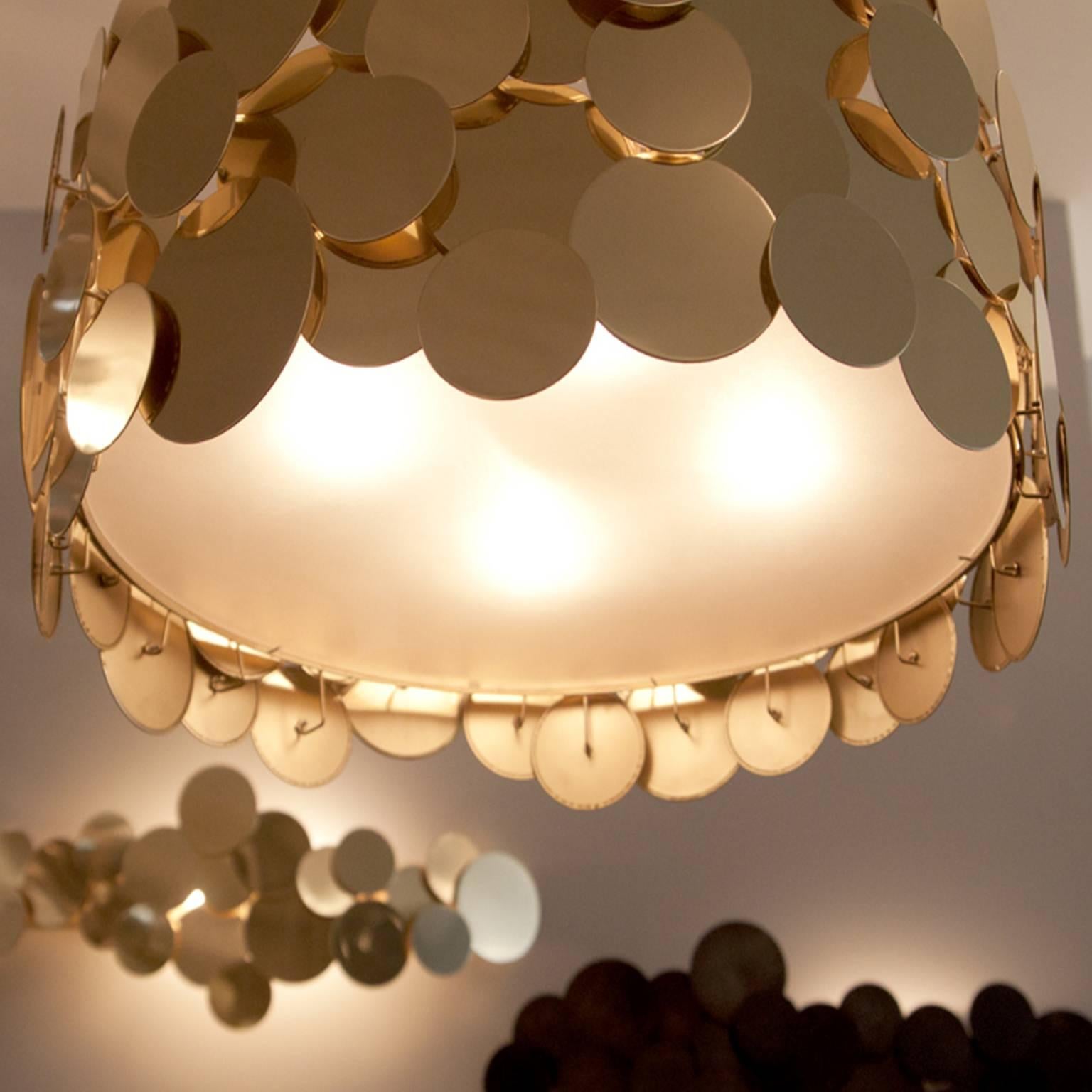 Polished brass metal disc chandelier
Measures: 41” W x 26” D x 16" H
Approximate lead time 11-12 weeks
Additional custom sizes and finishes available upon request
Made in our Tribeca, New York City, studio and showroom, by trans-LUXE