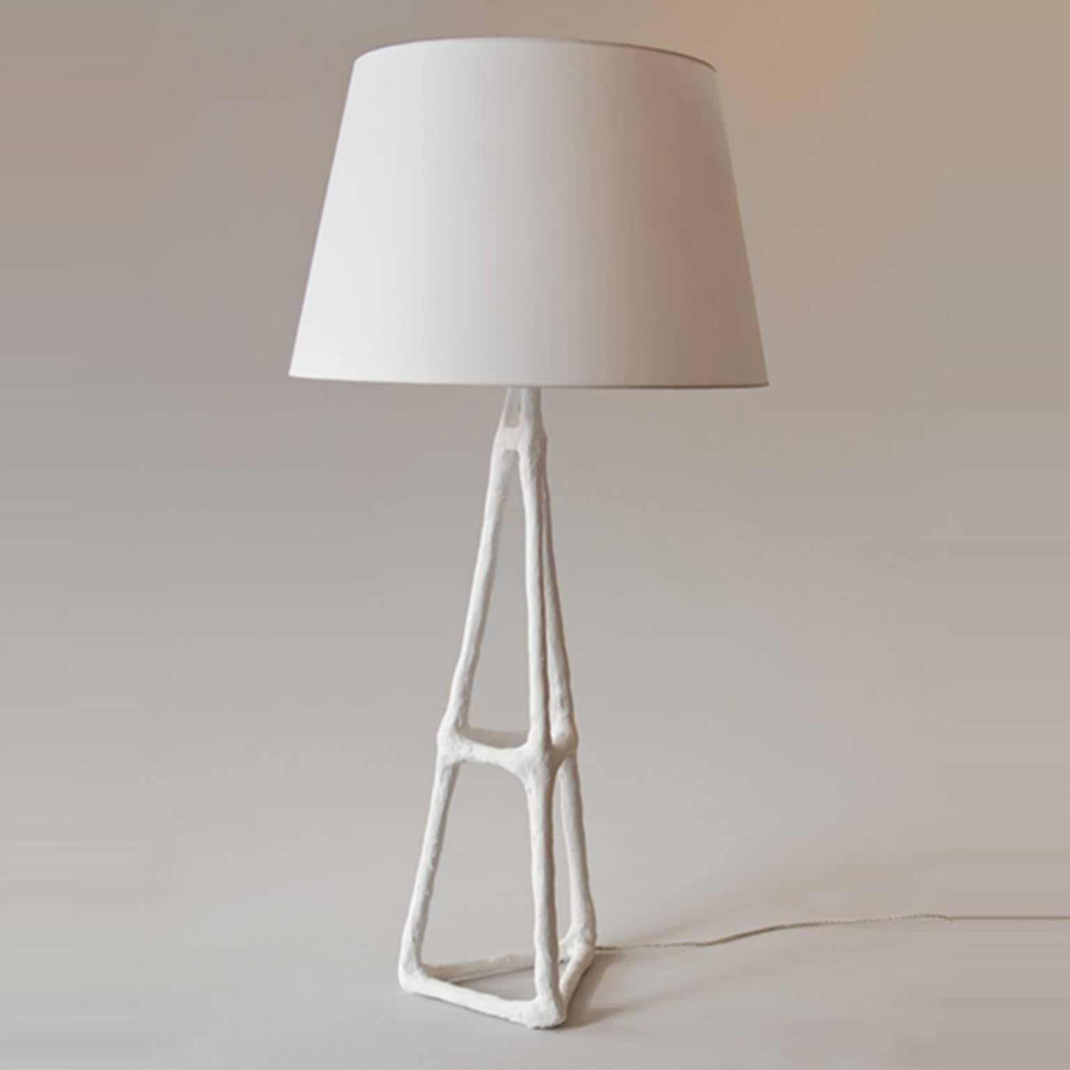 Artifex handmade plaster solid firm coated finish table lamp.
Shade included by trans-LUXE.
Shade size: 15" D top x 20" D bottom x 12 1/2" H.
Handmade plaster solid firm coated finish.
Measures: 35” H X 12” W *Base shown with