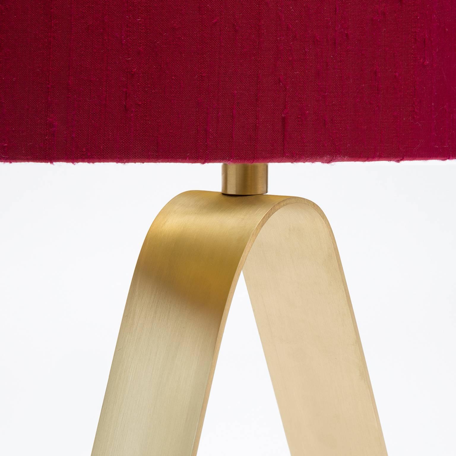 Triangula brass table lamp with red linen lampshade by trans-LUXE

OAH 22″ H

Base: 12″ H x 10″ W base

Linen lampshade: Oval 9" H x 15" W.

Ruby Red Linen Shade by trans-LUXE.

Made in New York City by trans-LUXE.

Additional custom