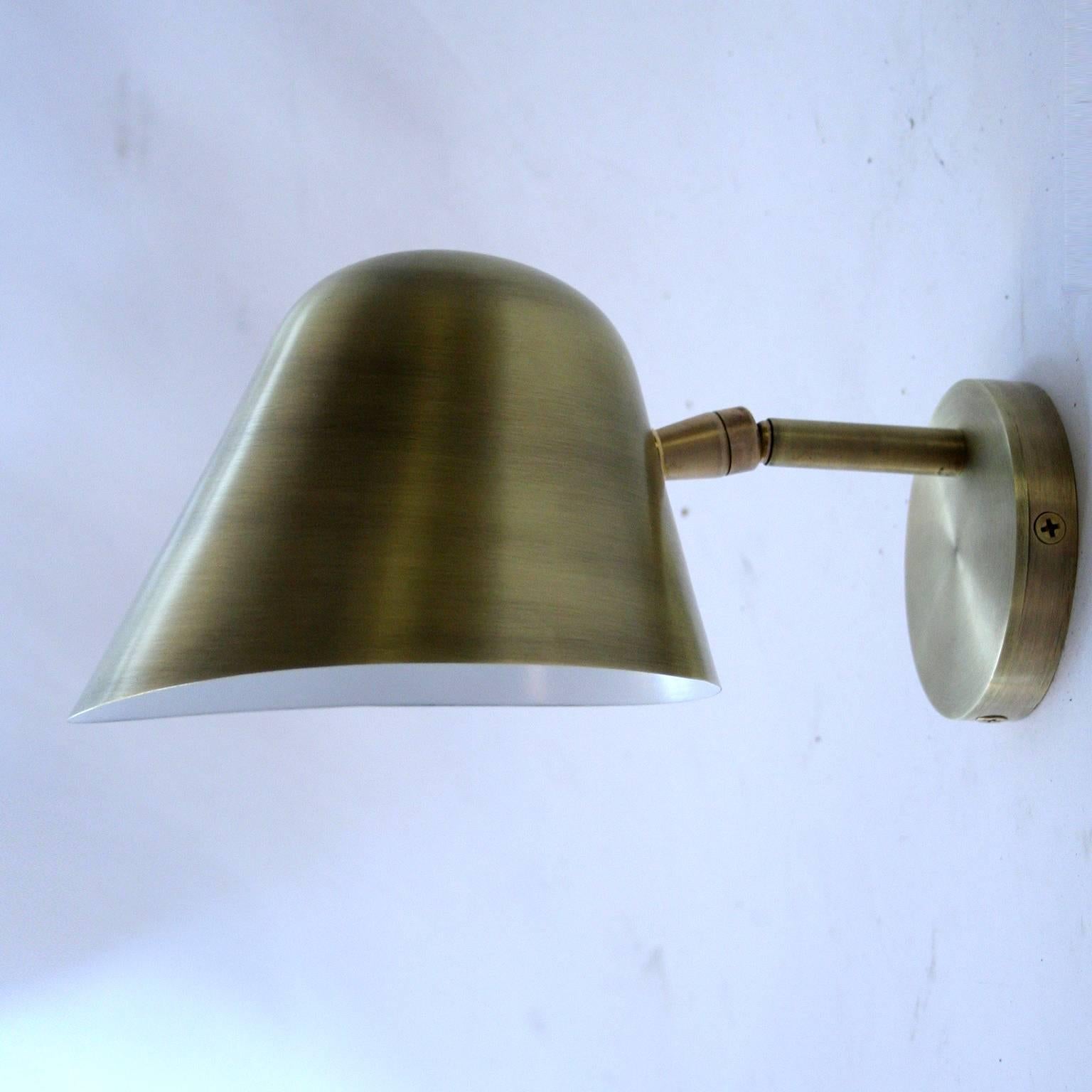 Rounded top, articulated sconce with slightly curved and flared bottom in shown in antique brass - other options available. 
Sustainable, 100% Recyclable, Zero Child Labor, 100% Made in USA
Made in our Tribeca studio and showroom in NYC.

Brass