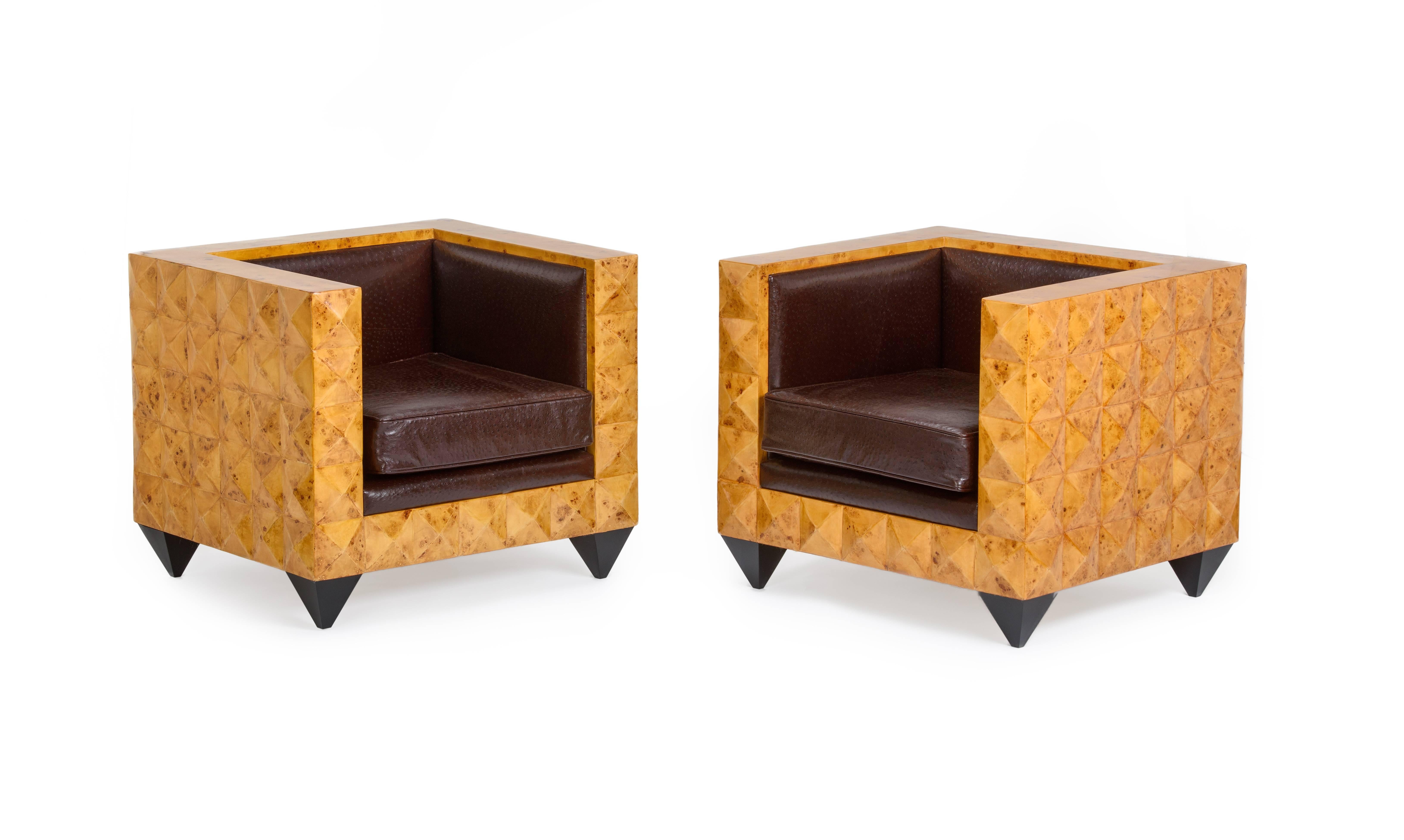 Gorgeous pair of buffed burr walnut pyramid armchairs in a most unusual shape, resting on black lacquered pyramid legs, reupholstered in a unique Cognac Ostrich printed leather, removable cushion cover with single piped detail.

Stunning center