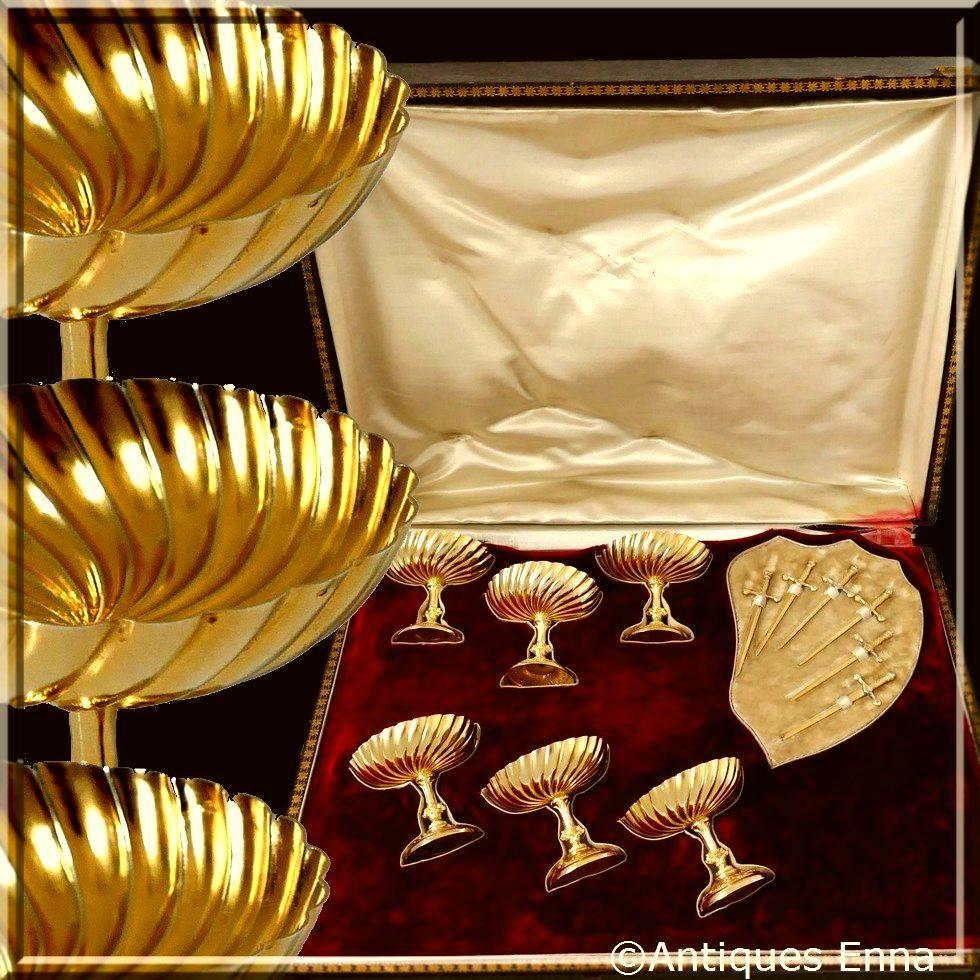 Extremely rare French all sterling silver and 18-karat gold 12 pieces crudité, strawberry for the Champagne or olive for the cocktail. 

Serving dish set six pieces with Rococo style bases and spiral fluted bowls associated with six swords shaped