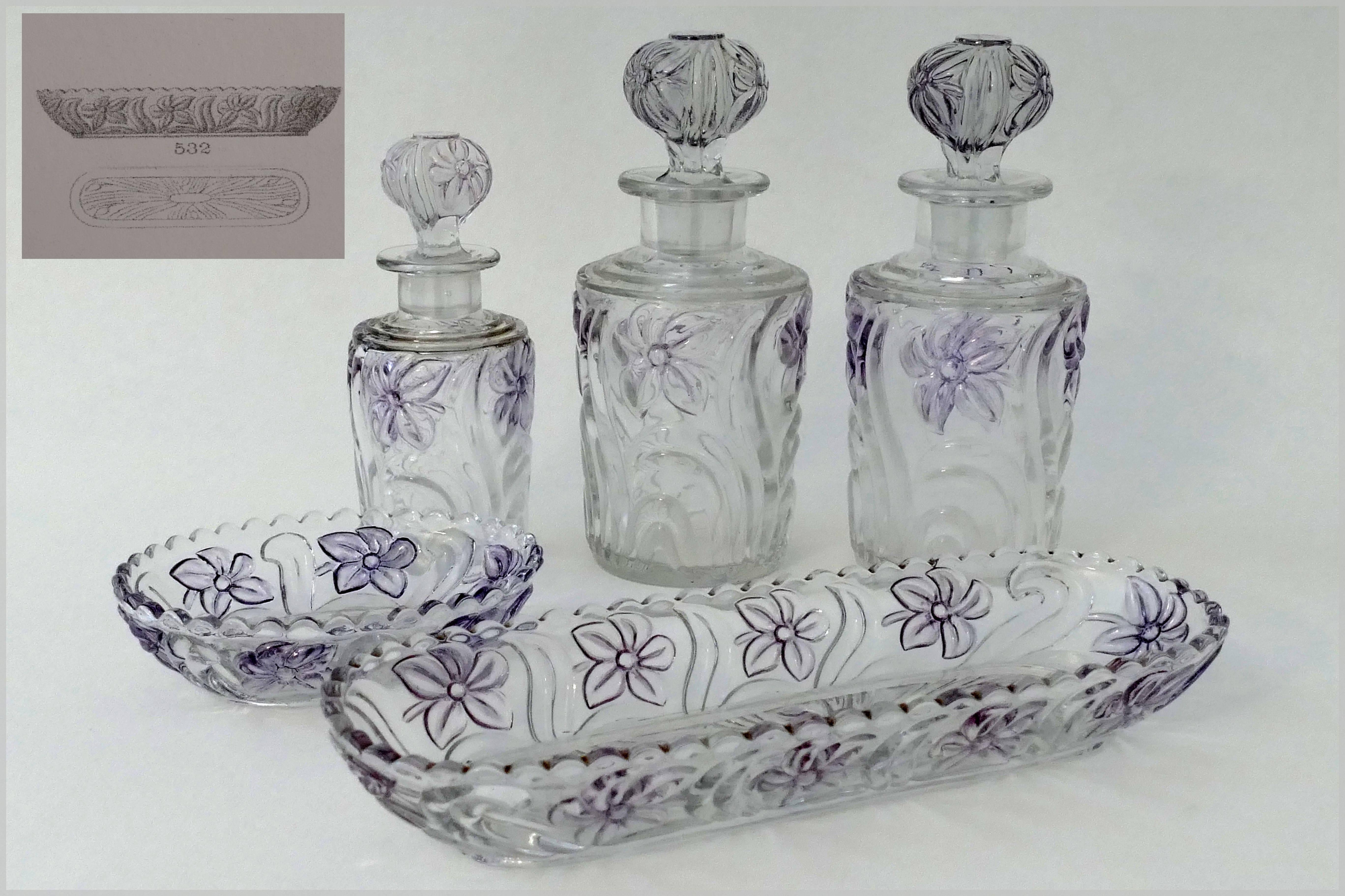 Fabulous French Saint Louis crystal dresser or vanity set of five pieces. Comprising of three bottles, a comb holder and soap dish. Amazing color amethyst reflections on floral decor. 

Heavy, and bright, all pieces are marked Saint Louis in relief.