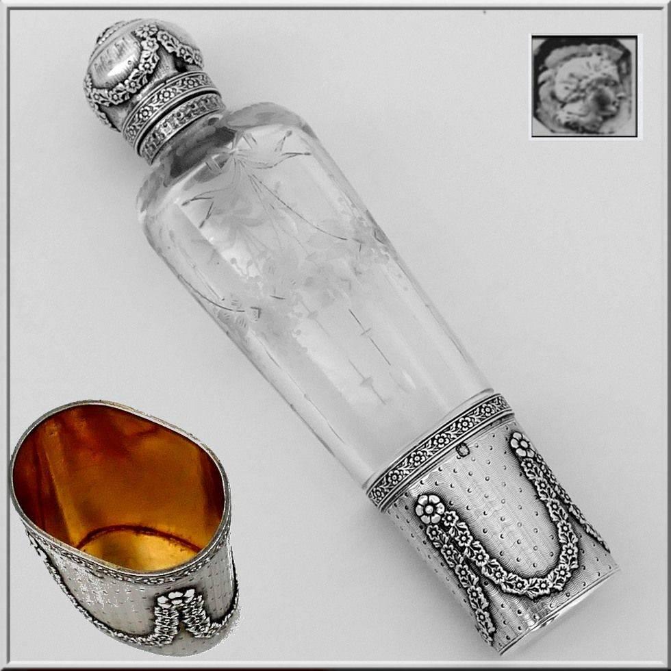 Antique French sterling silver 18-karat gold glass engraved opera/travel liquor hip flask

Head of Minerve first titre for 950/1000 French sterling silver guarantee. The quality of the gold used to recover sterling silver is a minimum of 750 mils