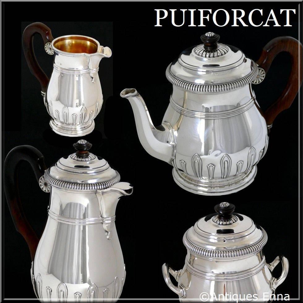 The set includes a teapot, a coffee pot, a covered sugar pot and a creamer. No monograms. A set of high quality. 

Head of Minerve first titre for 950/1000 French sterling silver vermeil guarantee. The quality of the gold used to recover sterling