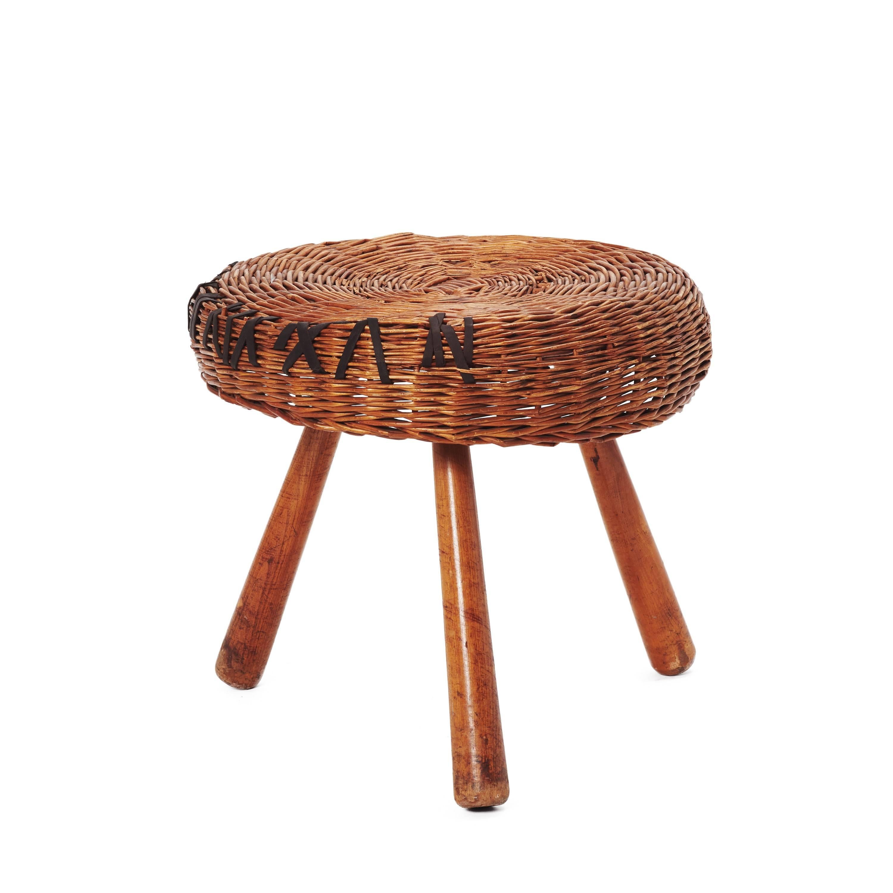 Wicker stool designed by Tony Paul, circa 1950. Manufactured in Netherlands. Walnut wooden legs, rattan seat. Natural patina on legs. Reinforced with chocolate brown leather.