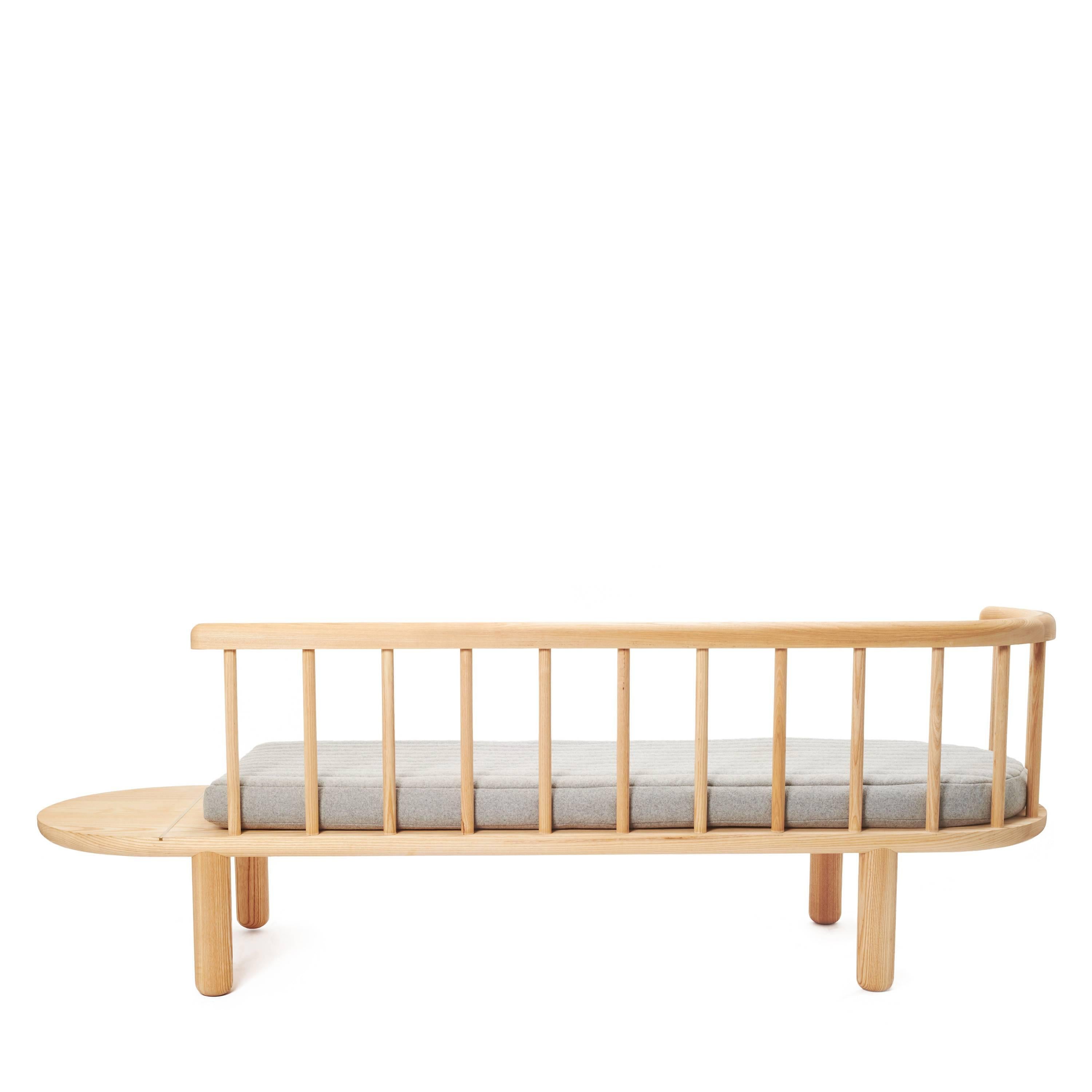 Keep your space fresh, Classic, and cool with this natural white oak spindle bench. Available with the gray cushion.