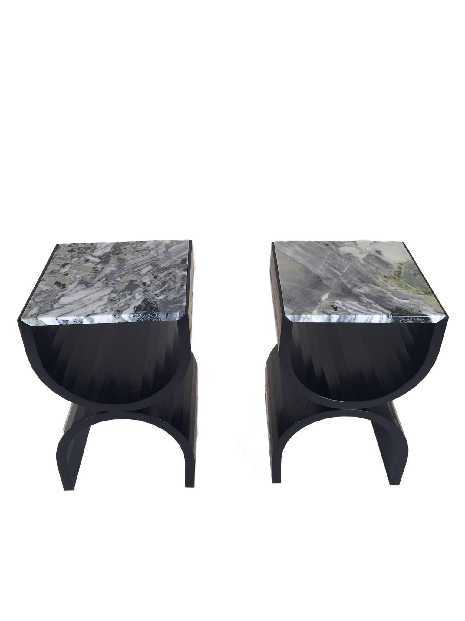 Bleached or ebonized ash or forms two gently faceted curves that cradle the marble tabletop. Each marble slab is hand selected and mitered to nest within the coopered frame. The solid wood curves feature grain matched detailing and a bold Art Deco