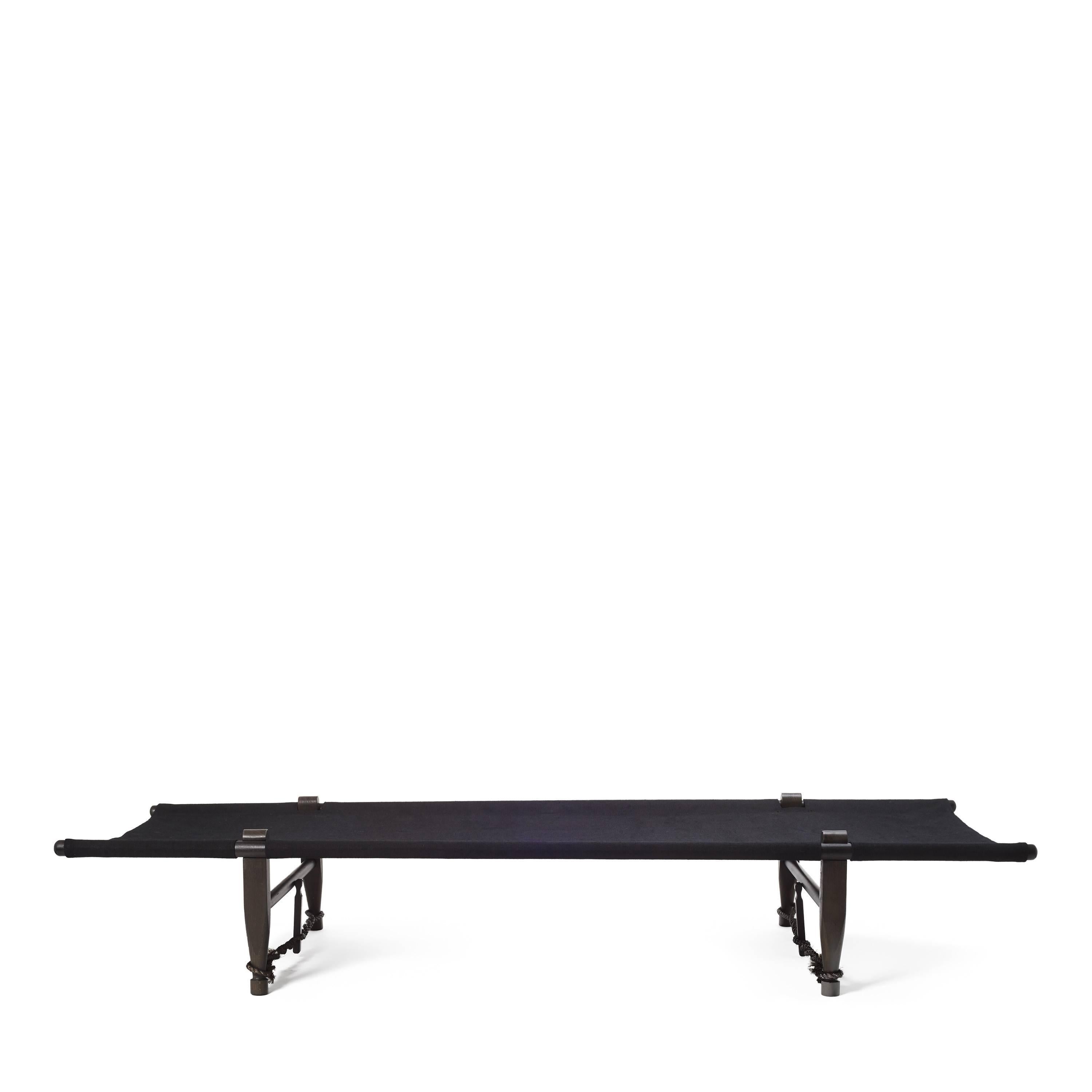 Designed in 1962 by Ole Gjerløv-Knudsen, this OGK black daybed is portable, light, comfortable, and fully functions as a coffee table by day and a place of rest at night. Made of black stained beech wood, black natural linen cover, and black sisal