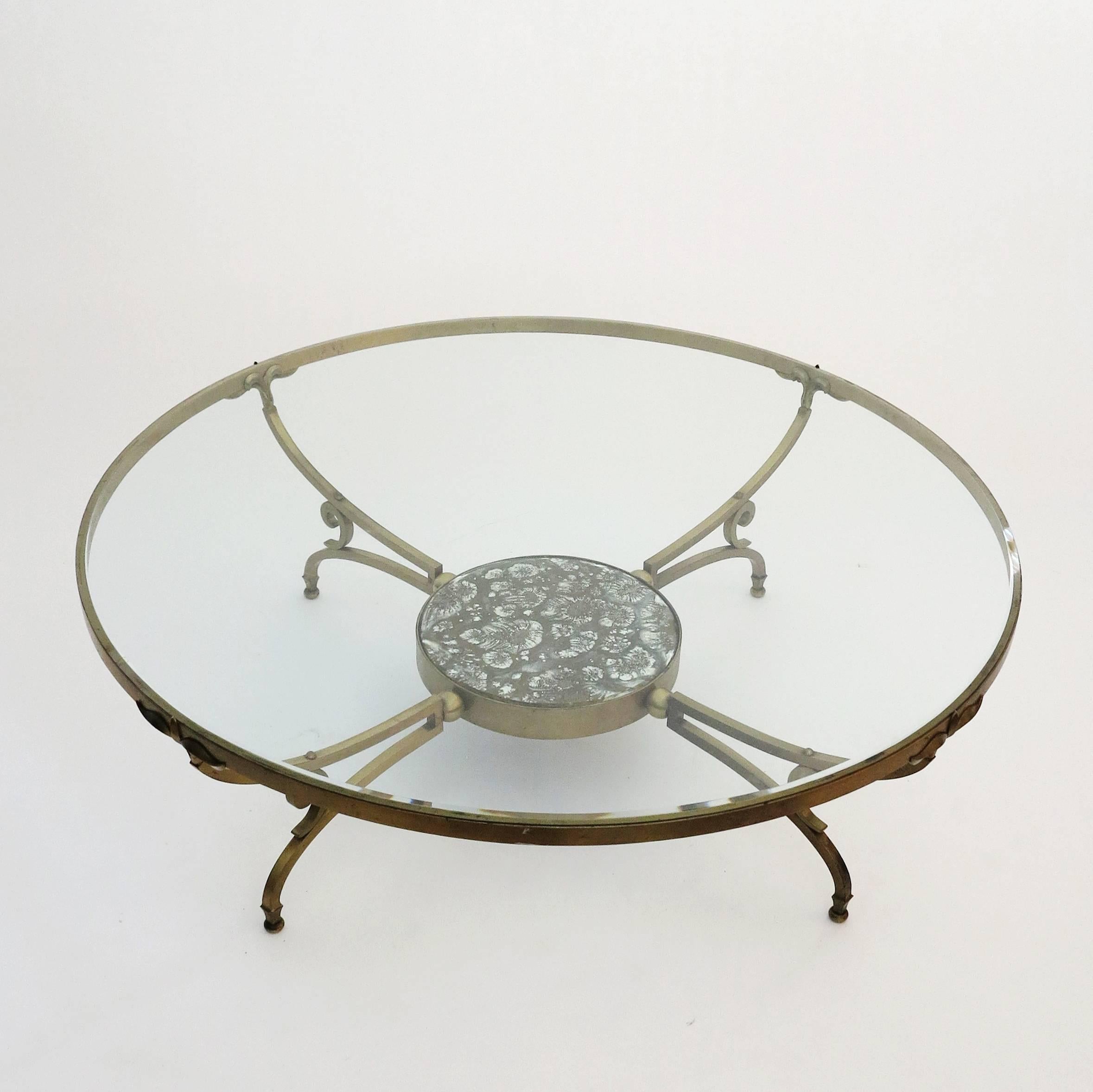 Luxurious round coffee table designed by Arturo Pani. Manufactured in solid bronze and beveled glass with an elegant églomisé glass detail in the lower level.