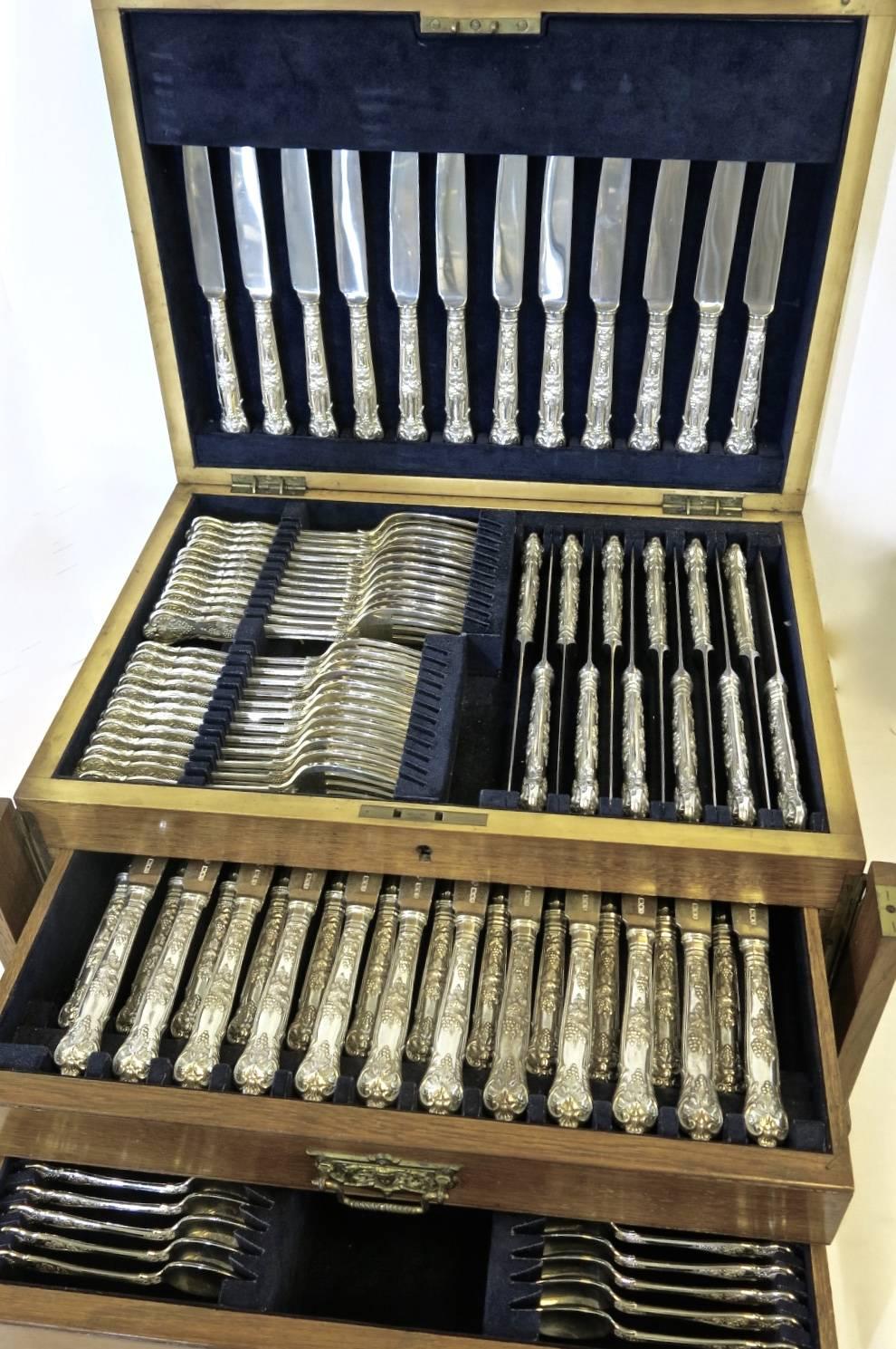 English sterling silver 'Bright Vine' pattern flatware set complete for 12 people, including the all silver fish knives and forks in fitted case. The entire set is sterling silver, except the blades of the dinner and cheese knives which are