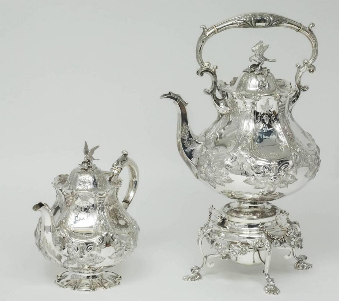This beautiful Victorian sterling silver tea and coffee set is complete and original, comprising tea pot, coffee pot, cream jug, sugar bowl and large tilting hot-water kettle. Each piece is beautifully hand-chased with six flat panels and a delicate