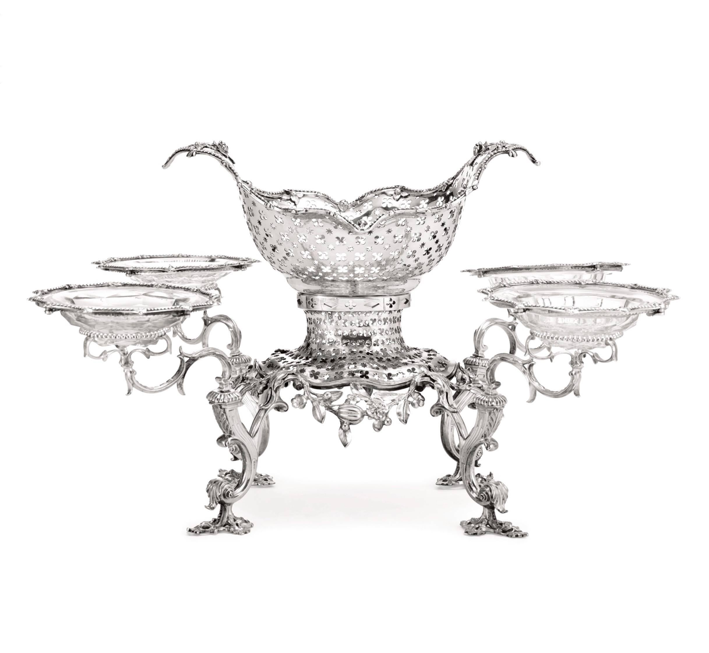 Georgian sterling silver Epergne:
Early George III, sterling silver and cut crystal Epergne by Thomas Pitts, London, 1760. Raised on four scroll supports on openwork feet, base and detachable central basket pierced with quatrefoils and stars,