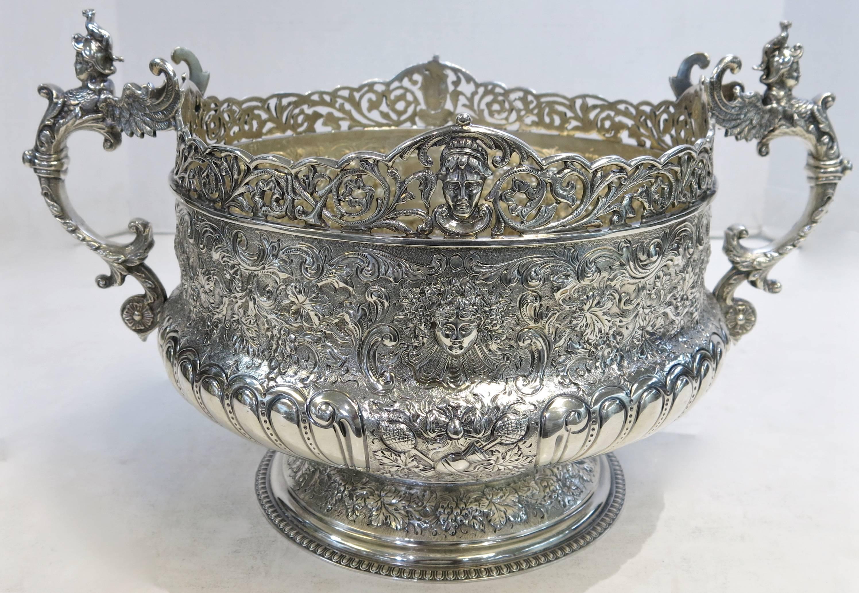 An exceptional quality, antique English, Victorian, sterling silver two handled bowl. The entire body is beautifully hand chased with the exception of a blank cartouche on one side. The round pedestal foot is hand chased to match, and the cast