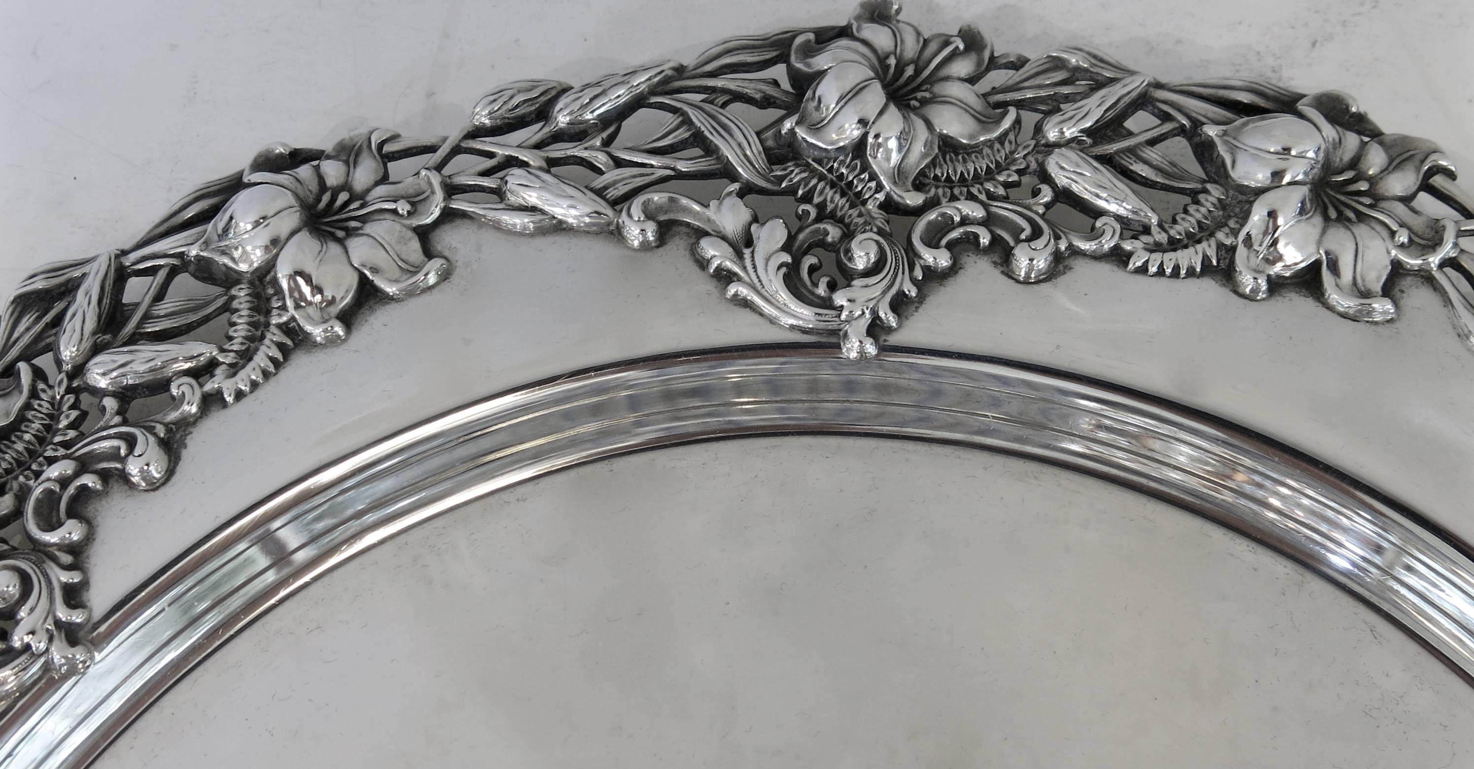 Sterling silver, Art Nouveau style, large round tray. Made By Redlich & Co For Spaulding & Co Of Chicago. 
The floral, three dimensional border is crisp and beautifully detailed. 
Measures: 16.25