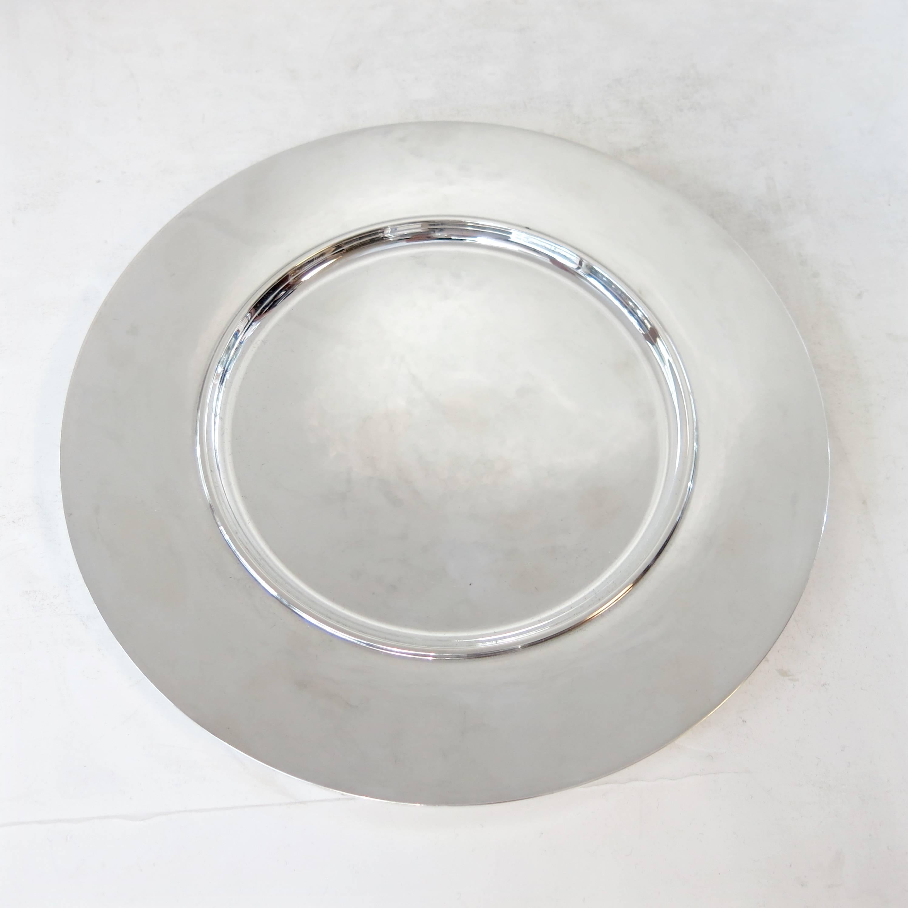 Georg Jensen complete set of 12 service plates no. 587C by Johan Rohde.
Each with a beautiful hand-hammered surface.
Measure: 11" diameter. Total weight for the 12 is 7,875 grams.
All are marked 587C, with various date marks.